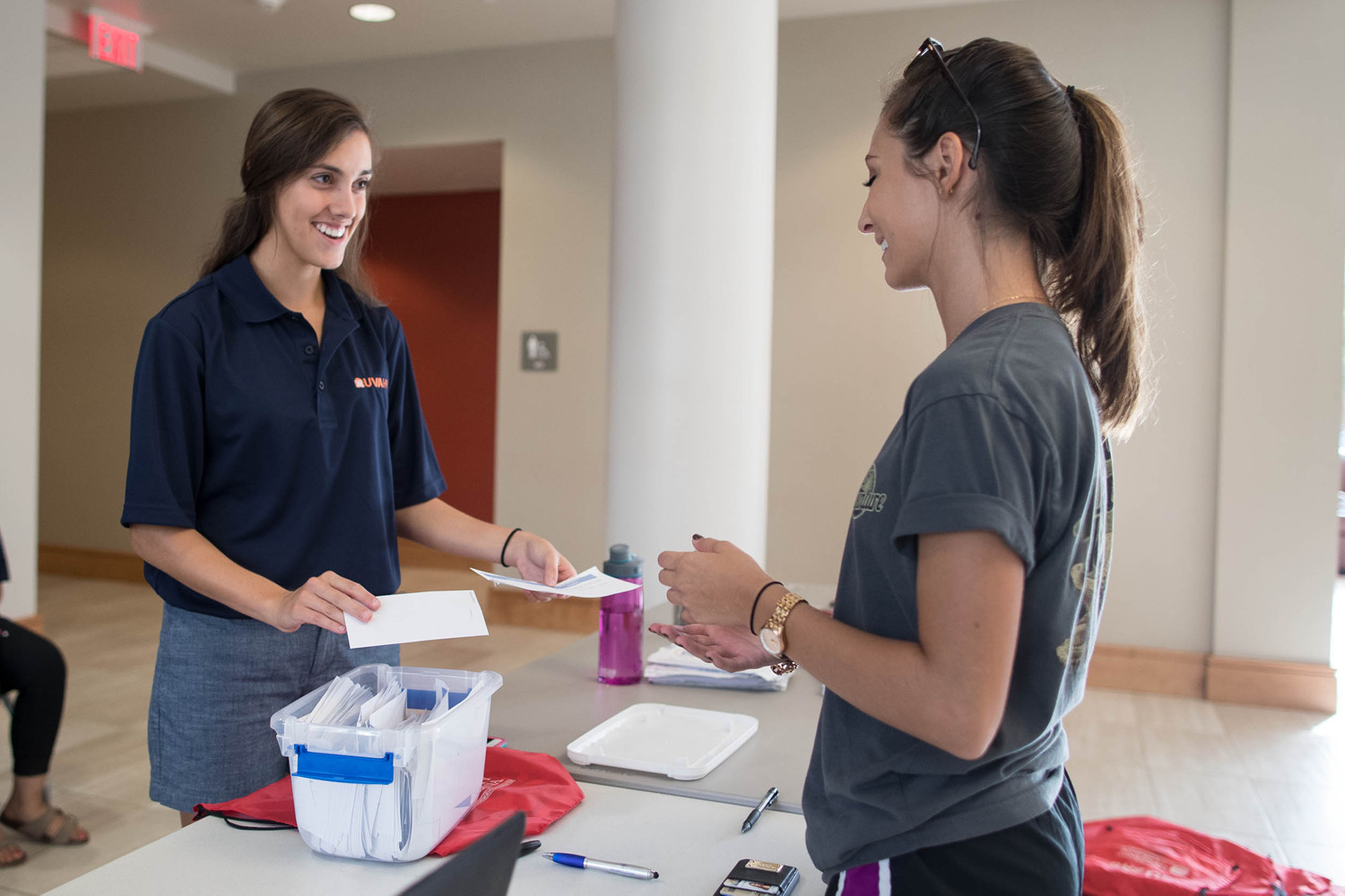 Resident assistant Allison Centineo welcomes a first-year student to Gibbons House. 