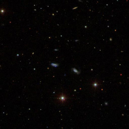 An image from the Sloan Digital Sky Survey shows a group of dwarf galaxies that are gravitationally bound together. (Sloan Digital Sky Survey)