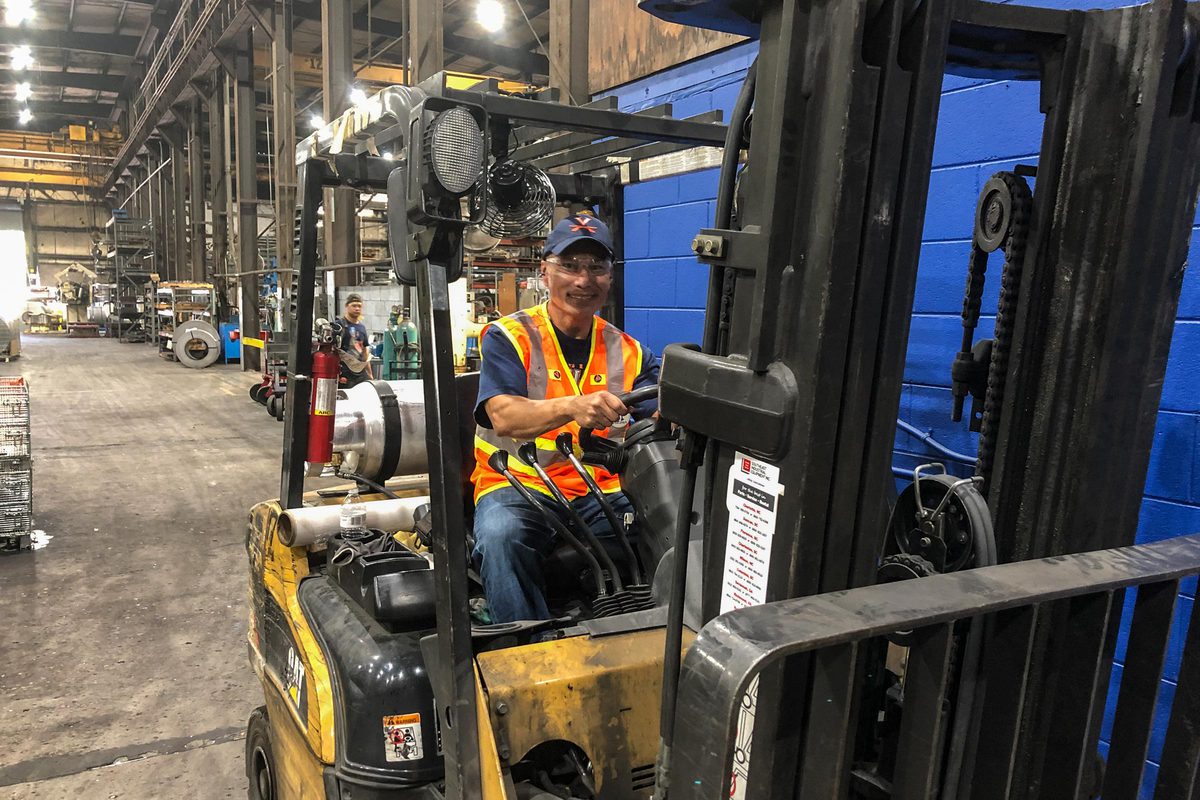Patasomcit driving a forklift 