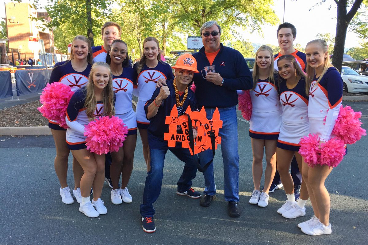 Patasomcit poses with UVA cheerleaders