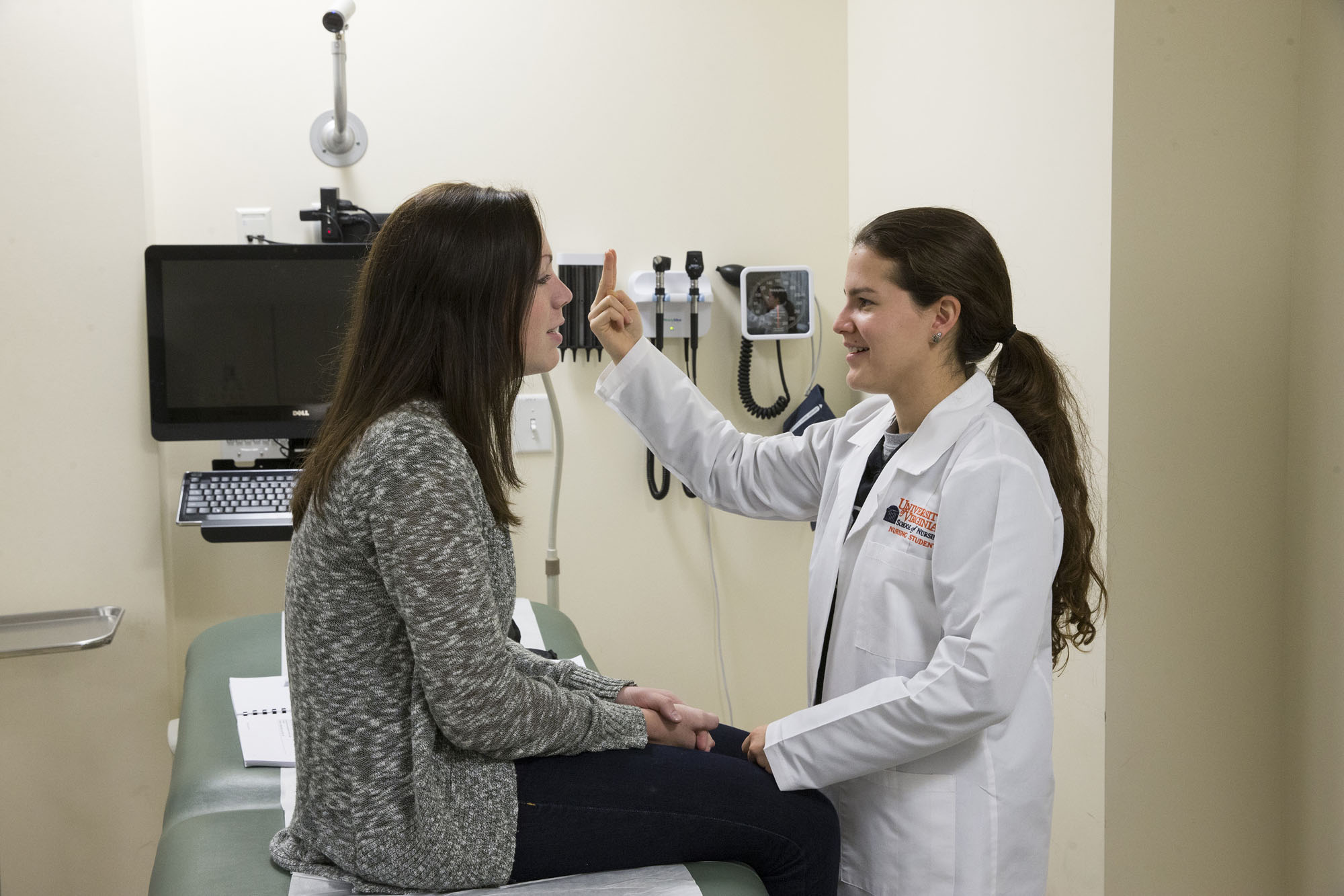 Second-year nursing students practice examining one another’s ears, eyes, noses and throats in the Mary Morton Parsons Clinical Simulation Learning Center.