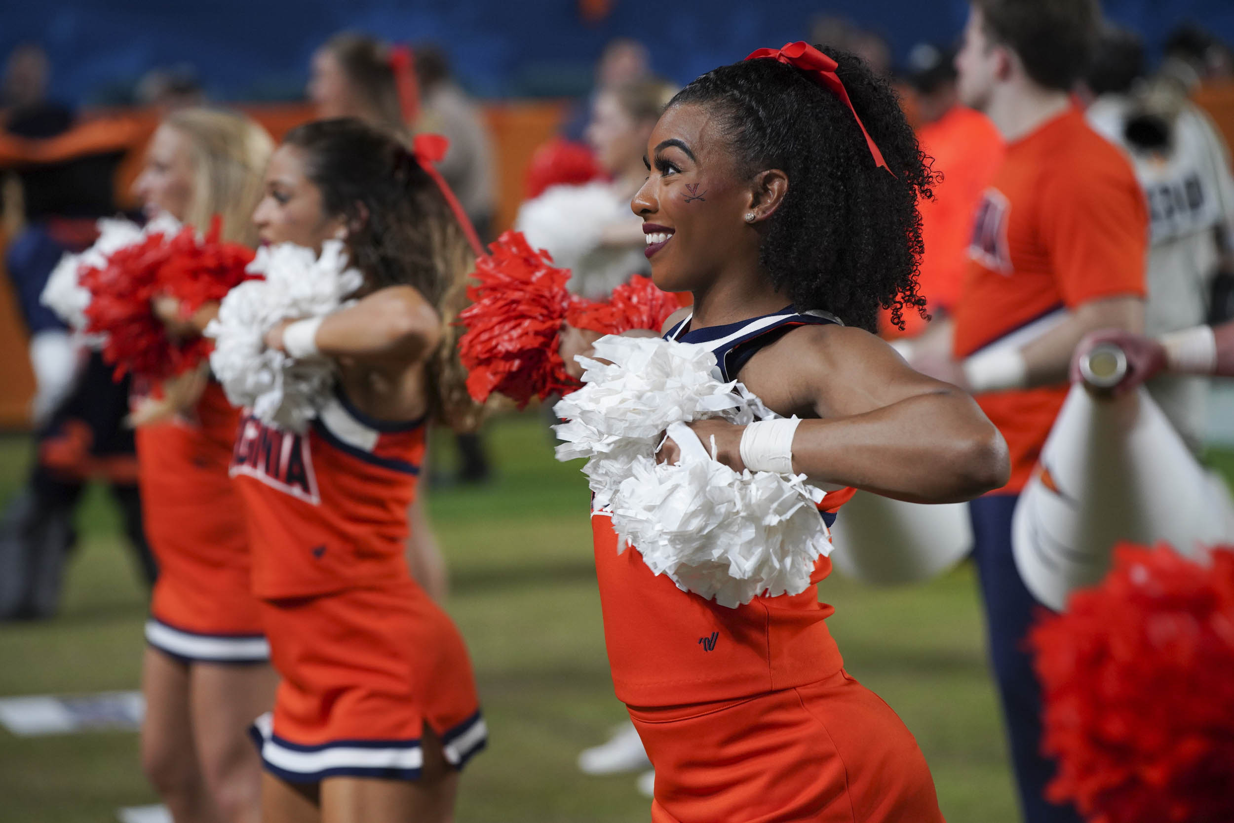 UVA's cheerleaders cheering on the side lines during the football game
