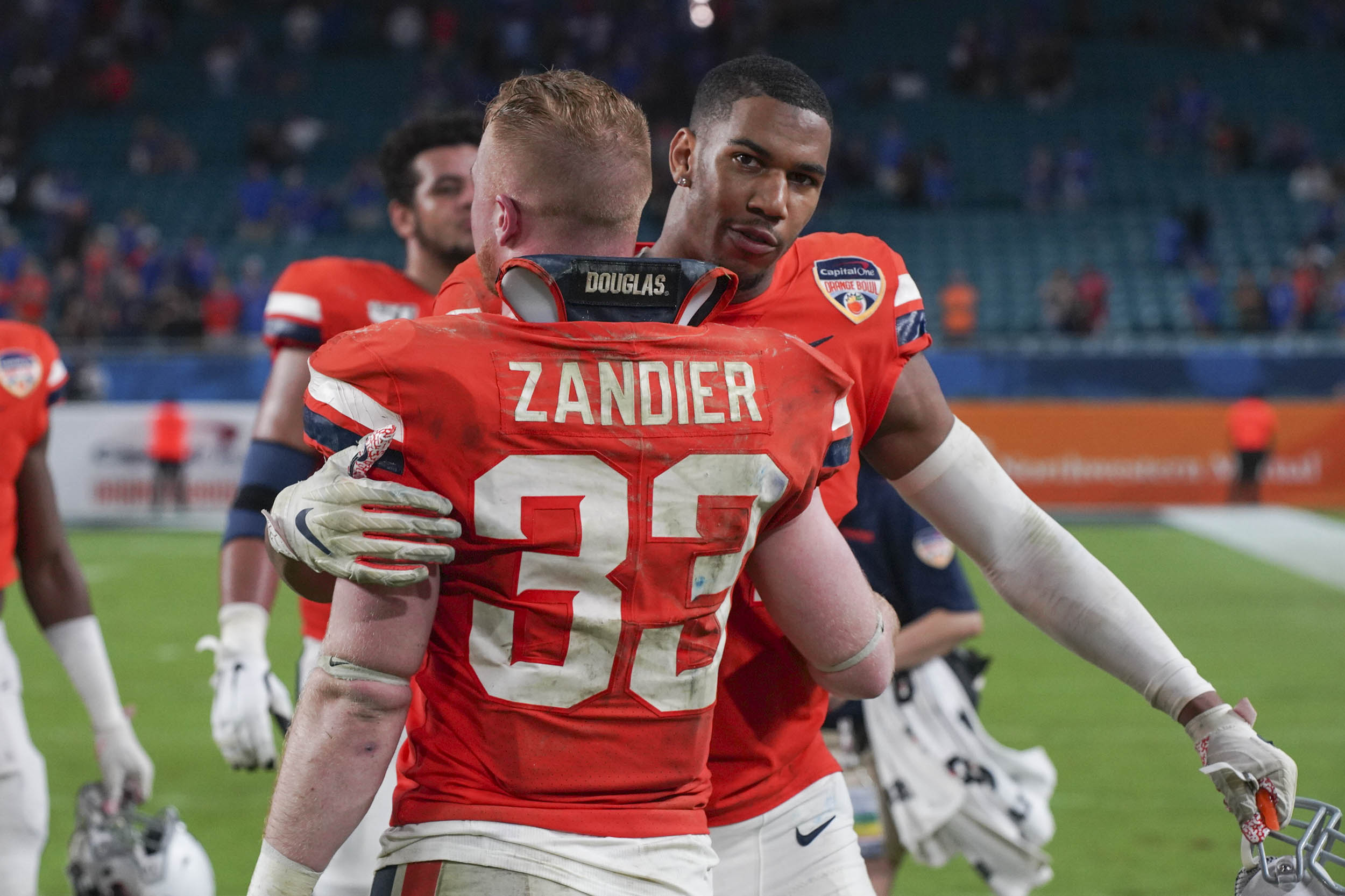 Zandier and teammate Charles Snowden share a hug after the game