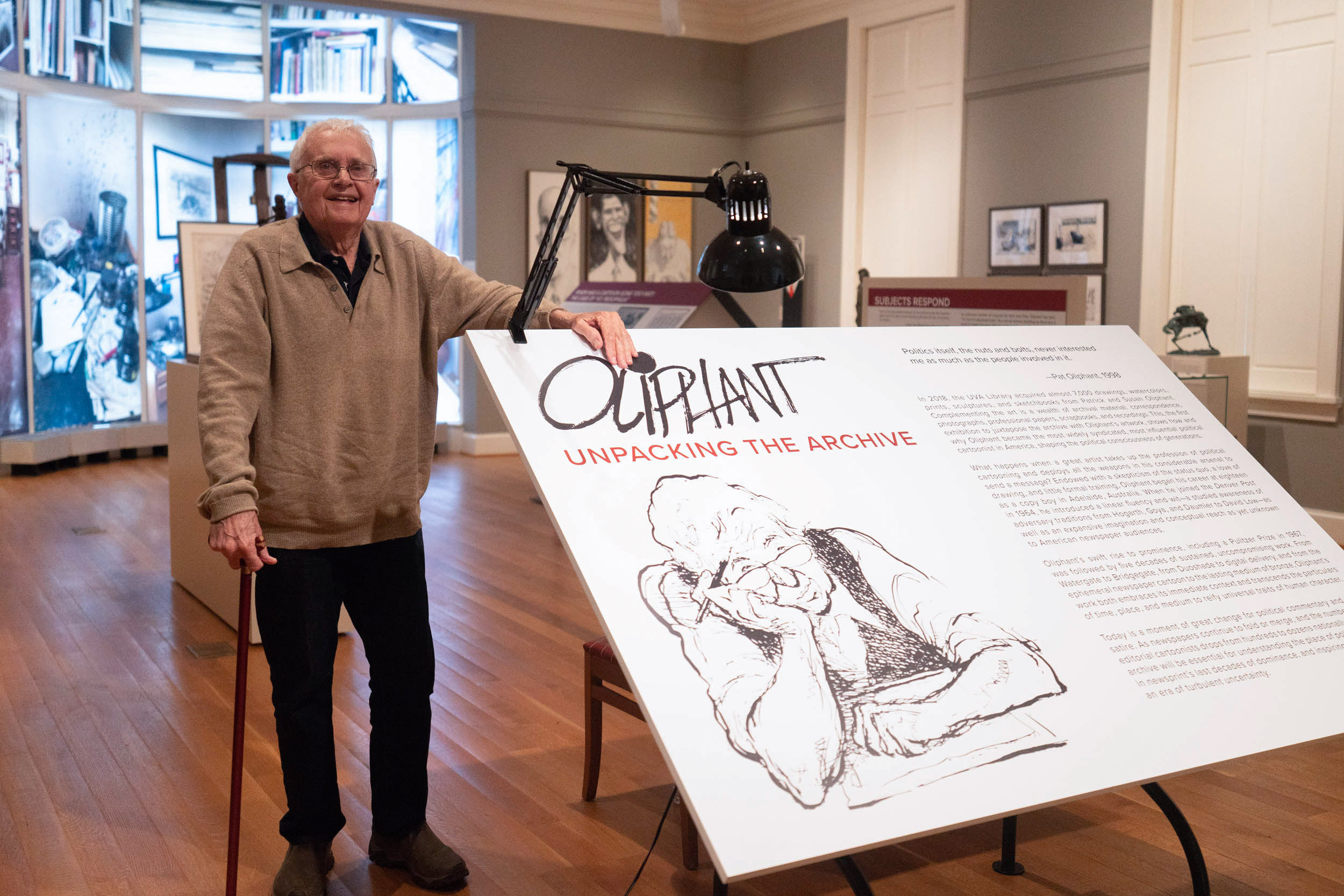 Oliphant stands in an exhibit about his cartooning of political topics