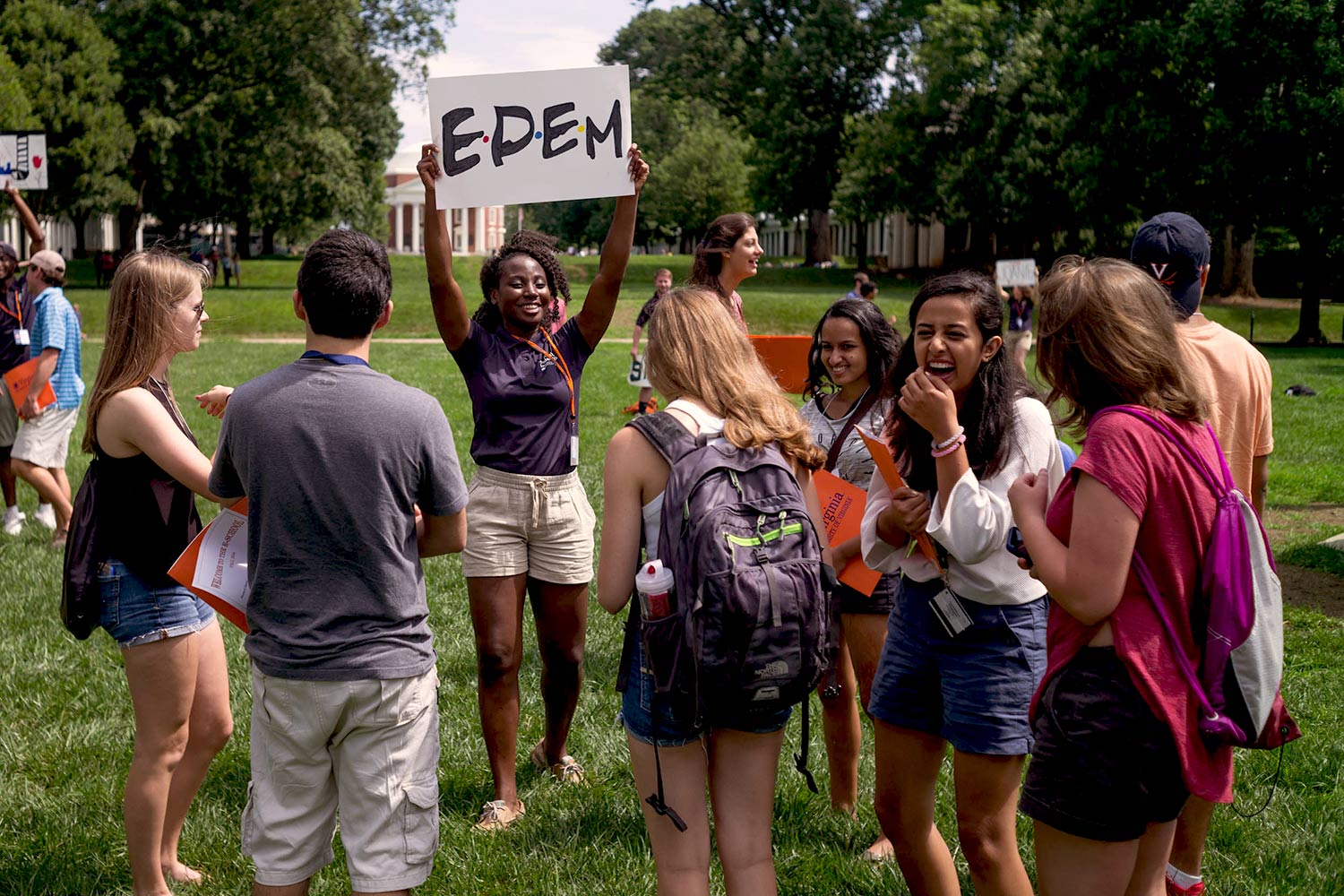 Orientation leaders greet students as they file out of Old Cabell Hall. 