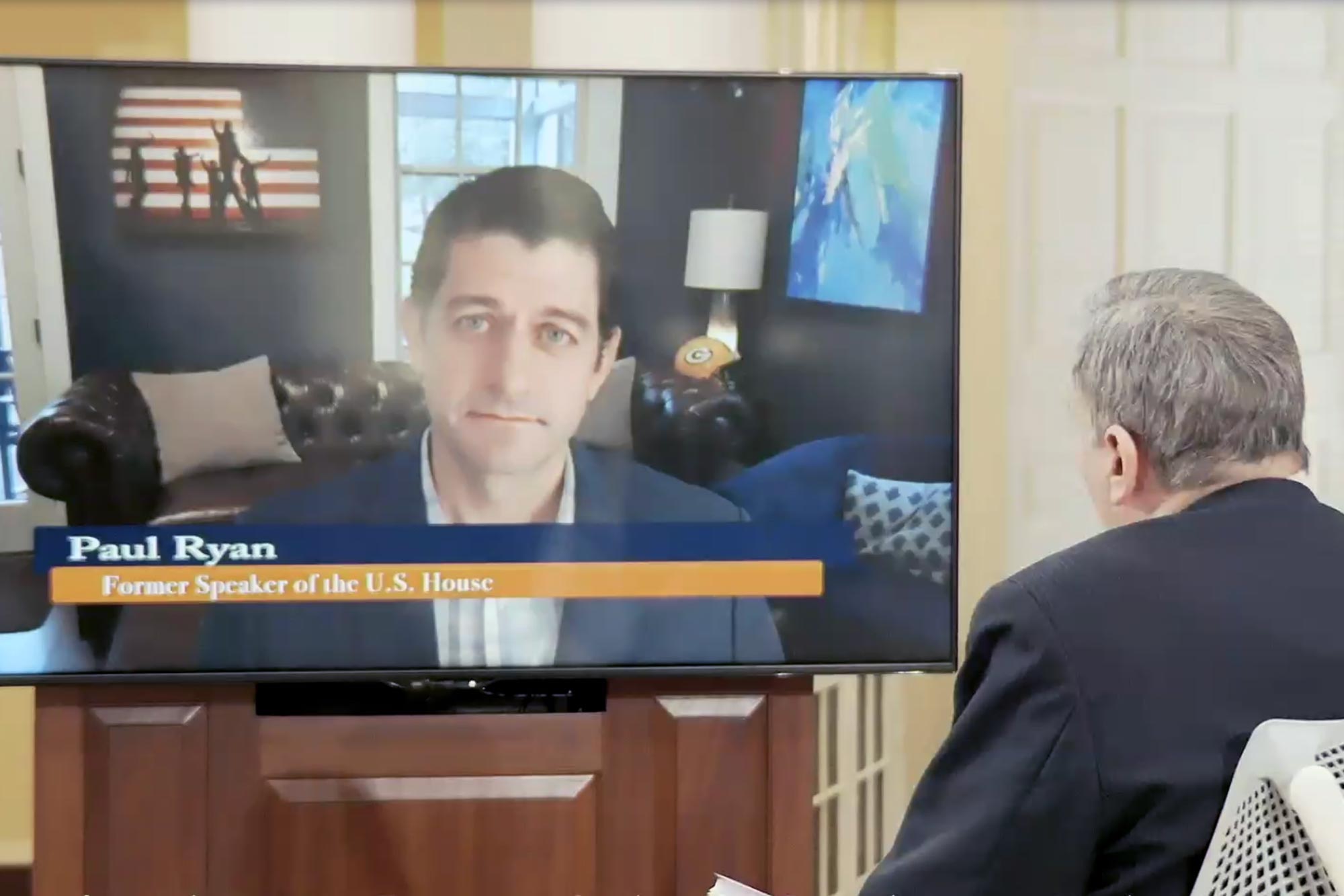 Paul Ryan on a tv screen speaking with Larry Sabato