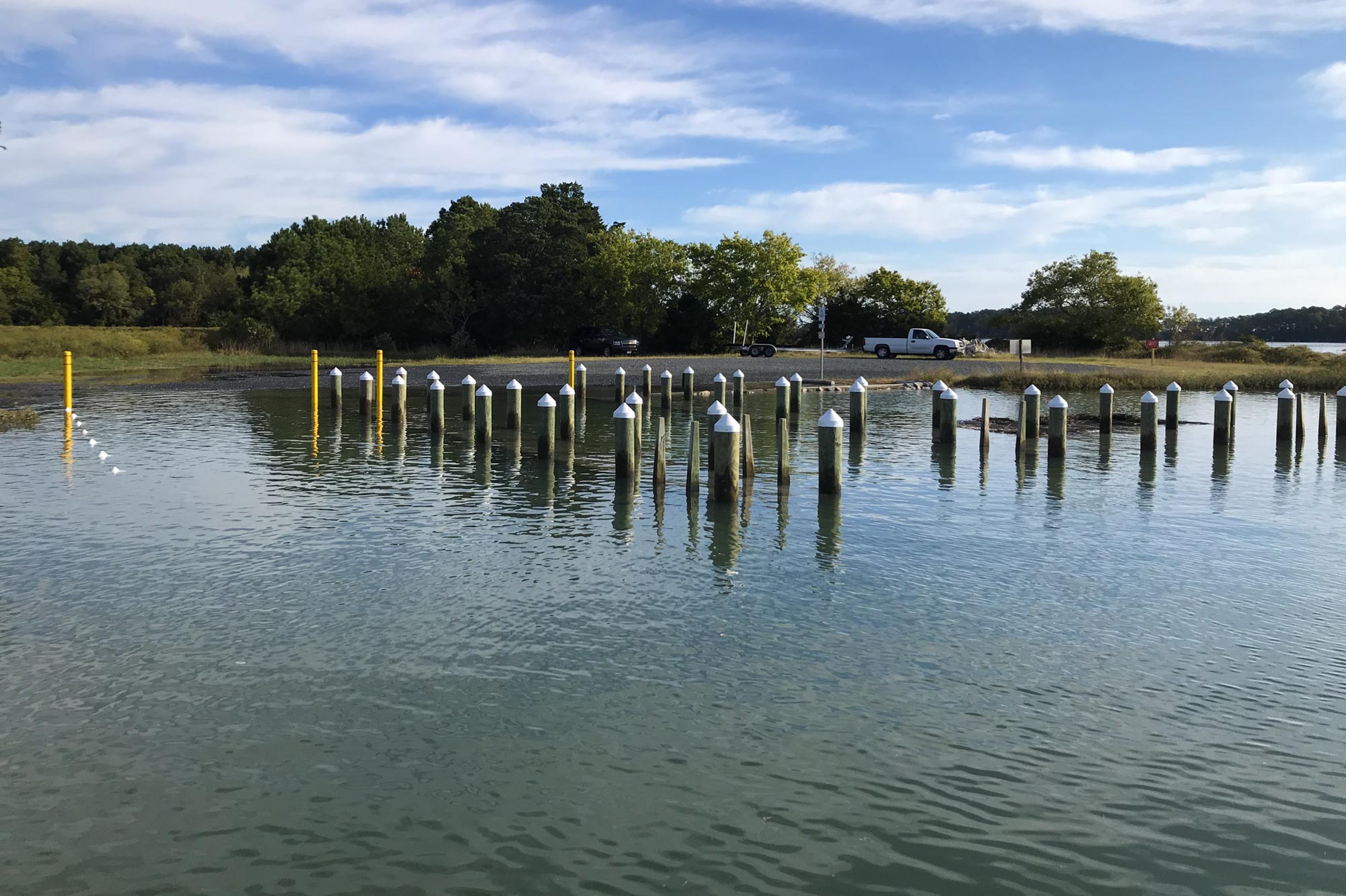 Flooded boat ramp with the pier posts sticking up