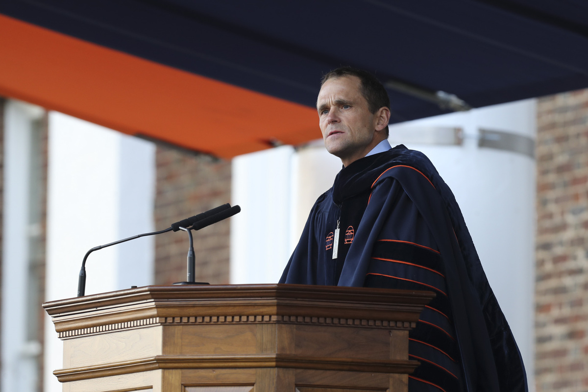 Jim Ryan, UVA’s ninth president addressing a crowd at a podium while in full graduation attire
