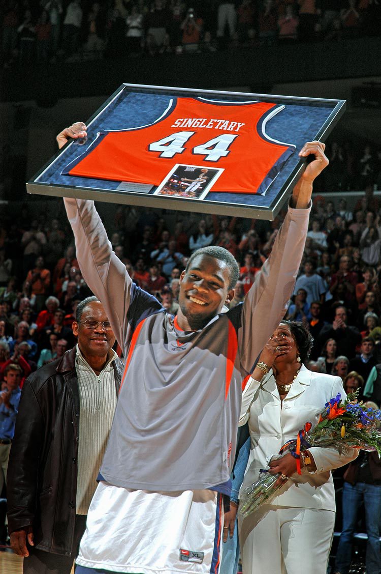 Sean Singletary holds up a jersey in a picture frame