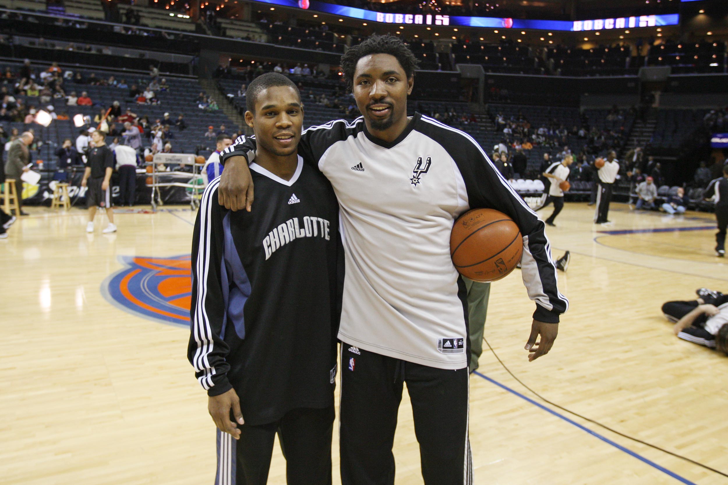 Singletary, left, and Roger Mason Jr., right, pose for a picture before an NBA game