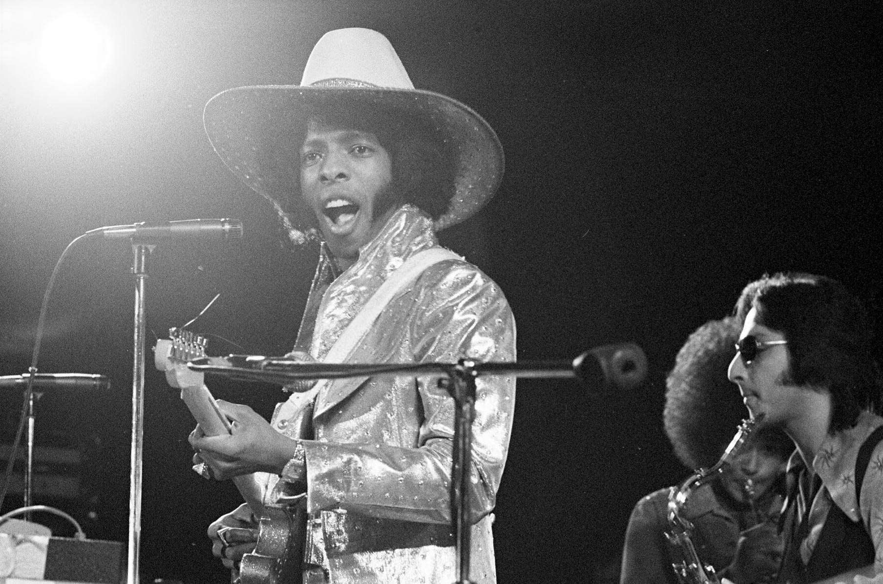 Black and white image: Sly and the Family Stone performing on stage