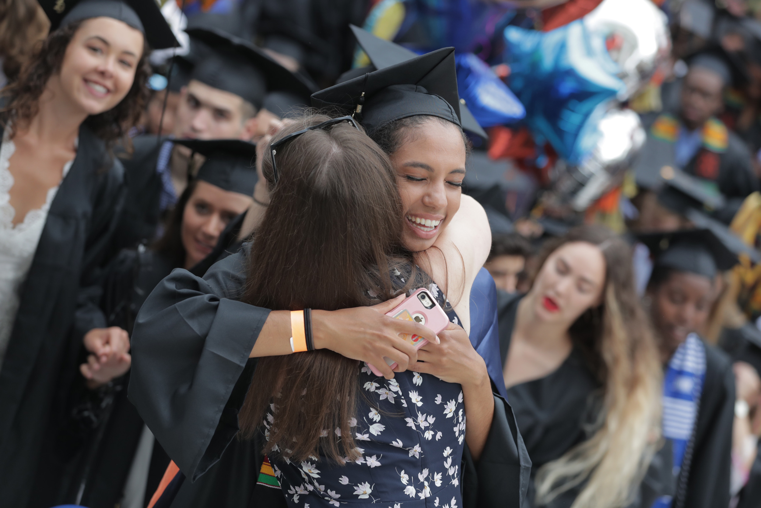 Graduate hugs a woman
