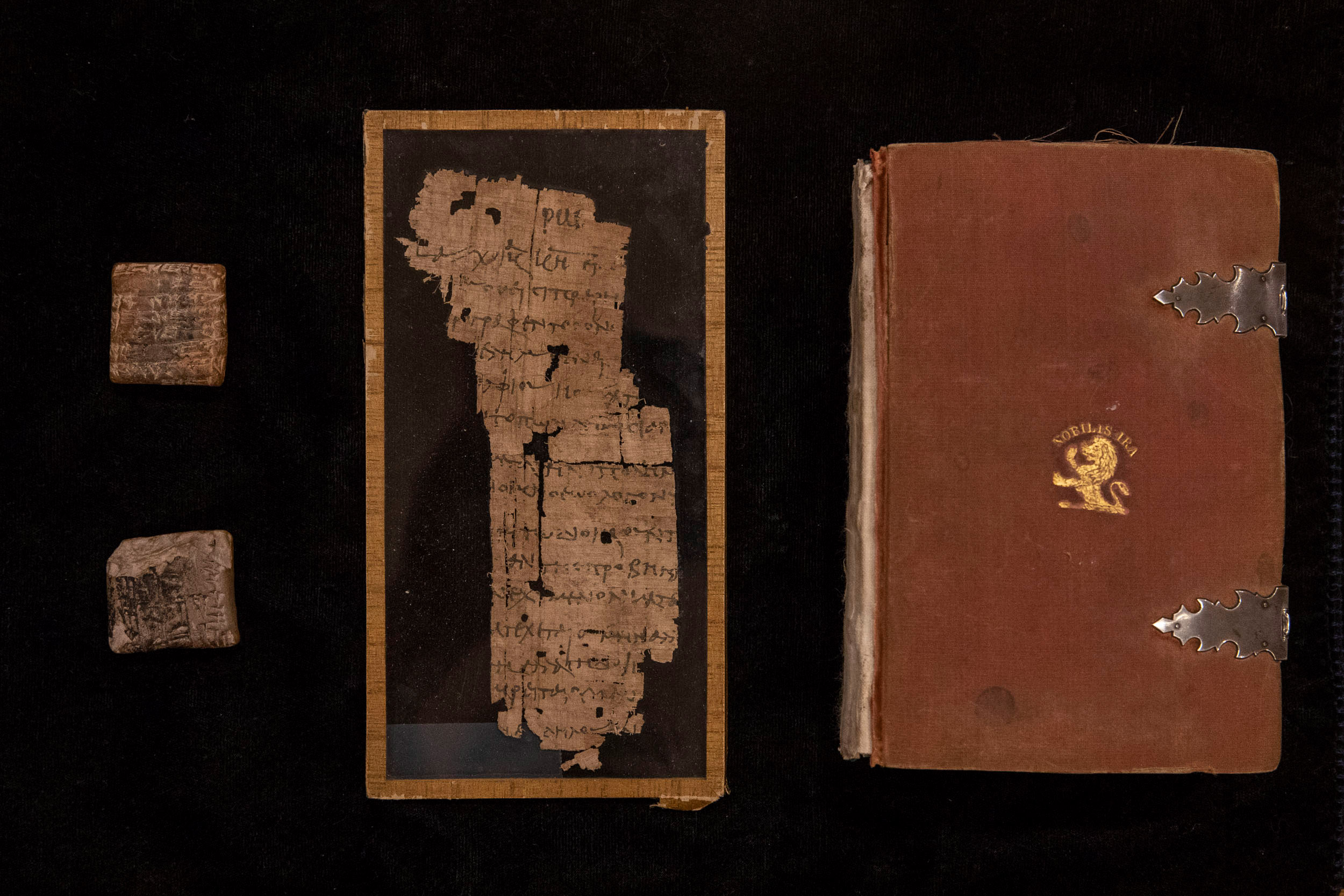 From left to right, a Babylonian clay tablet dating back to 2450 B.C., Middle: a piece of Egyptian papyrus from 100 A.D., and Right:  the revolutionary Paris pocket bible, circa 1270 A.D., handwritten on animal skin.