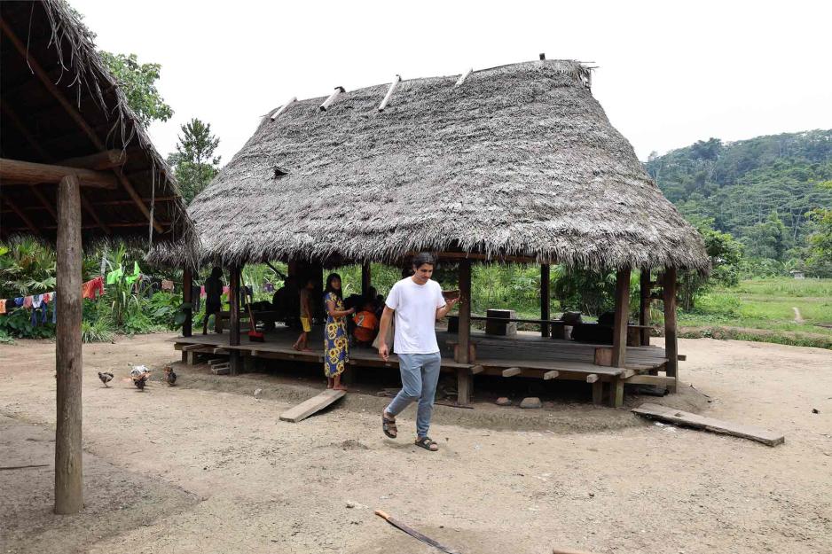 Jackson Khandelwal in front of hut in Ecuadorian village