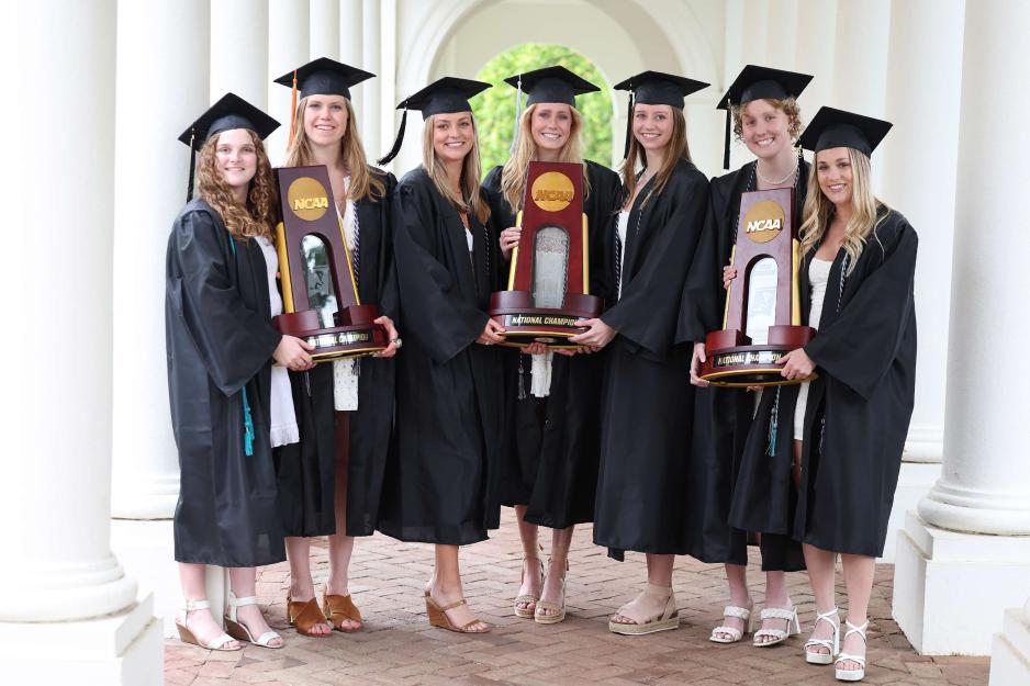 Athletes pose together in grad robes