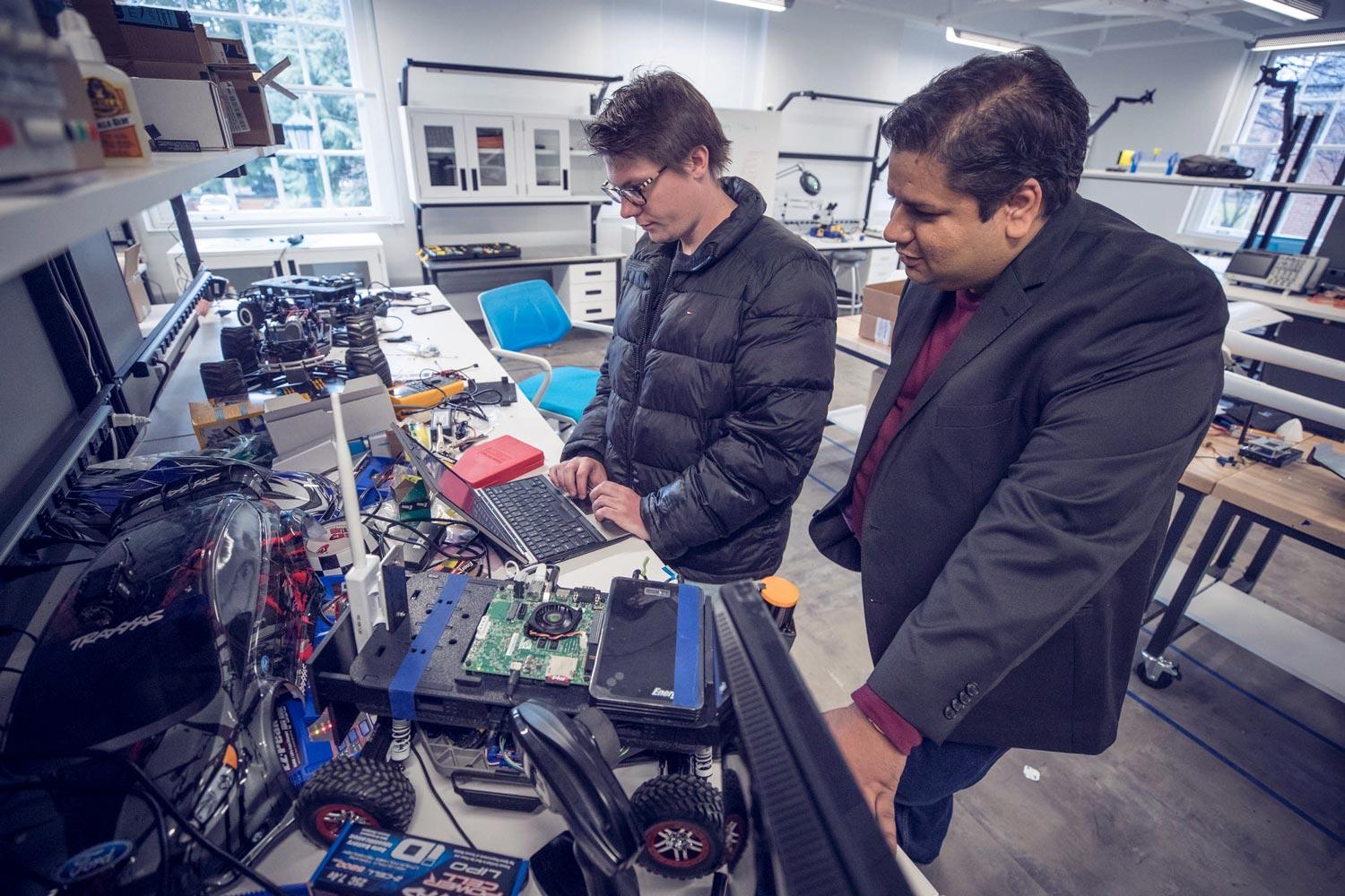 Matt Kerns, a fourth-year computer science student, works with computer science professor Madhur Behl on programming autonomous cars. (Photos by Sanjay Suchak, University Communications) Matt Kerns, a fourth-year computer science student, works with computer science professor Madhur Behl on programming autonomous cars. (Photos by Sanjay Suchak, University Communications)