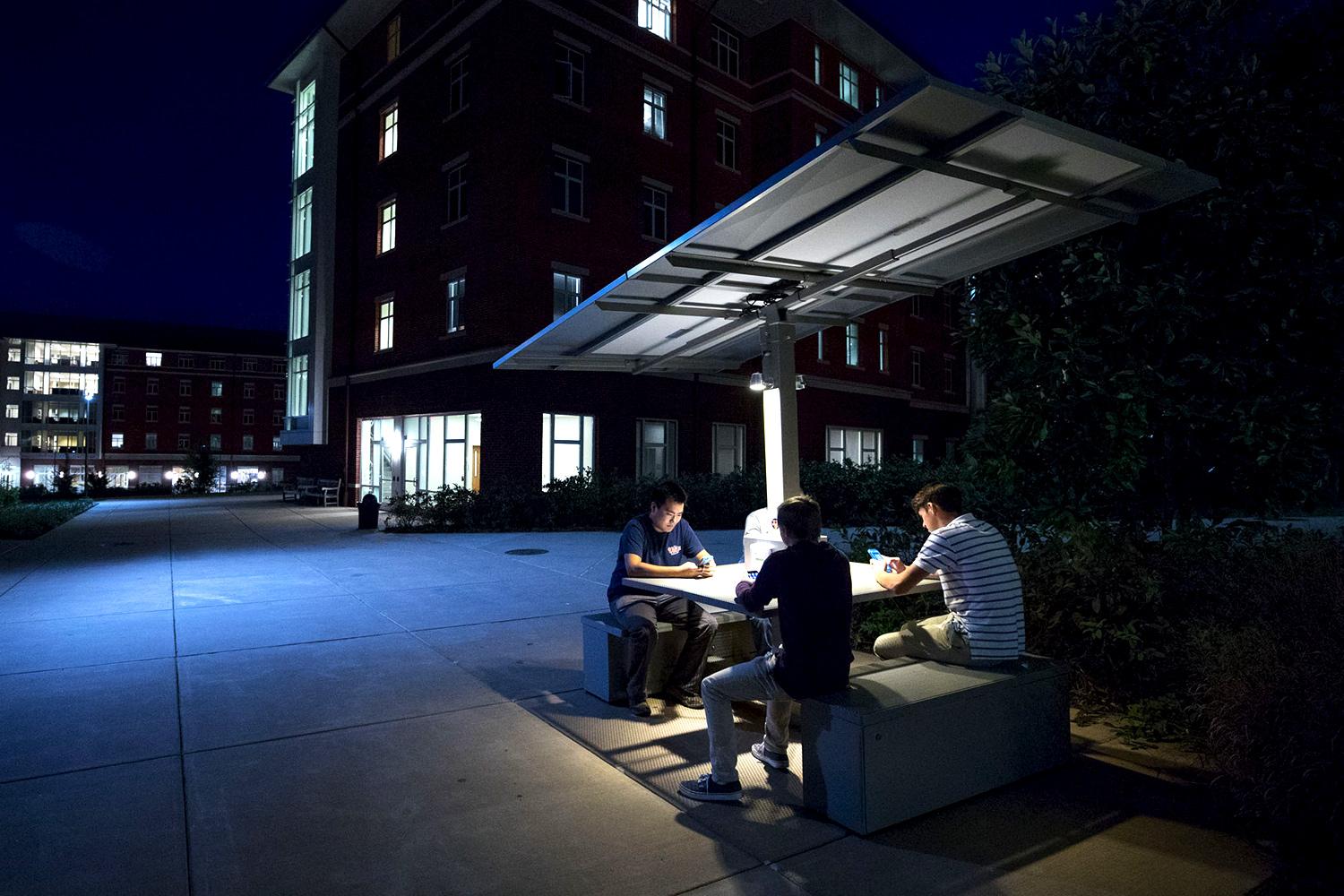 A student initiative resulted in the installation of a solar table outside Lile-Mapuin House, where students can recharge batteries while collaborating on projects. (Photo by Sanjay Suchak, University Communications) A student initiative resulted in the installation of a solar table outside Lile-Mapuin House, where students can recharge batteries while collaborating on projects. (Photo by Sanjay Suchak, University Communications)