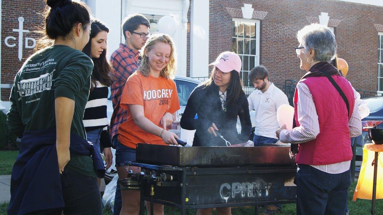 Students cooking pancakes on a griddle