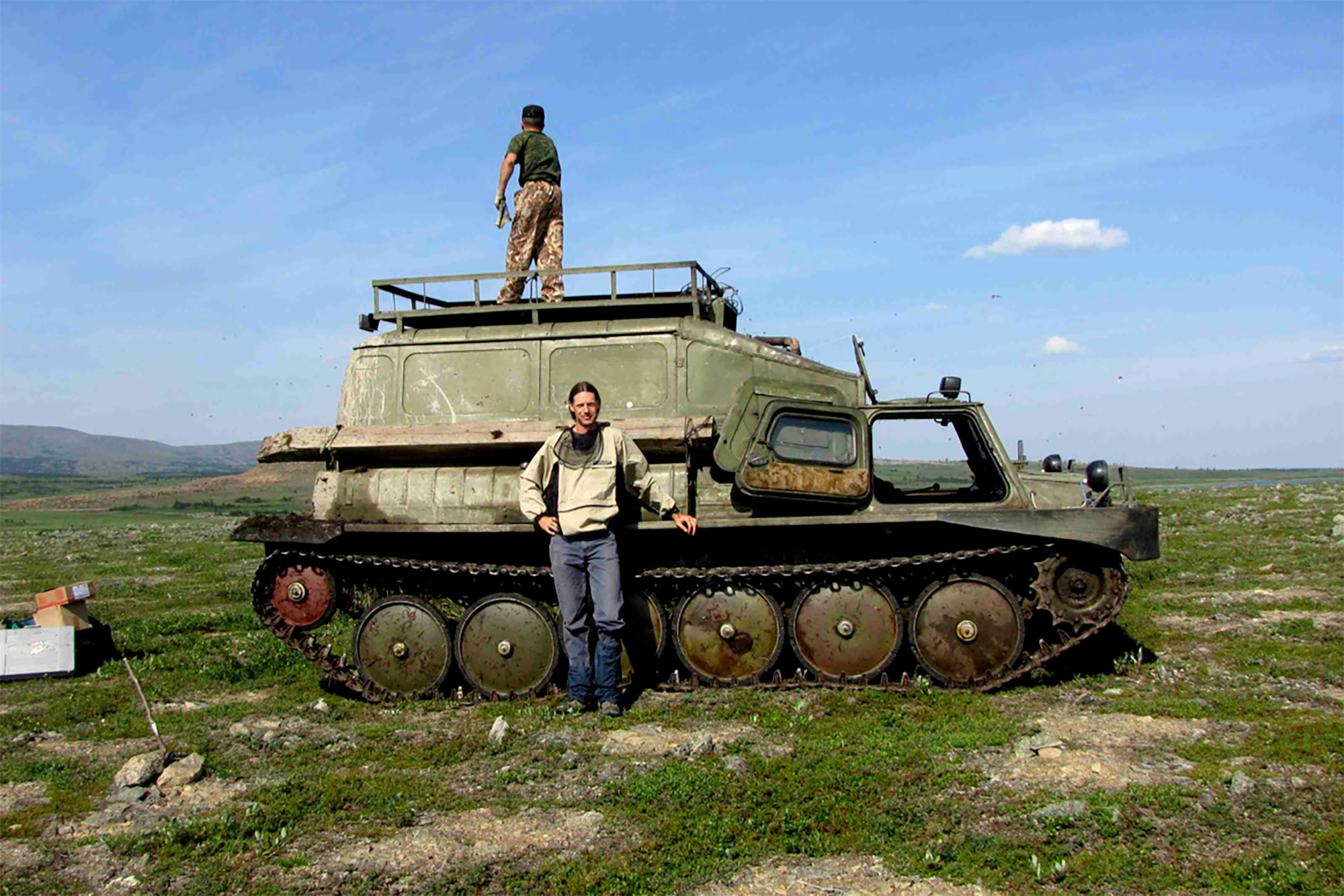 Researcher Gerald Frost stands before an old Russian armored vehicle he and Epstein used to study remote areas of Arctic tundra.