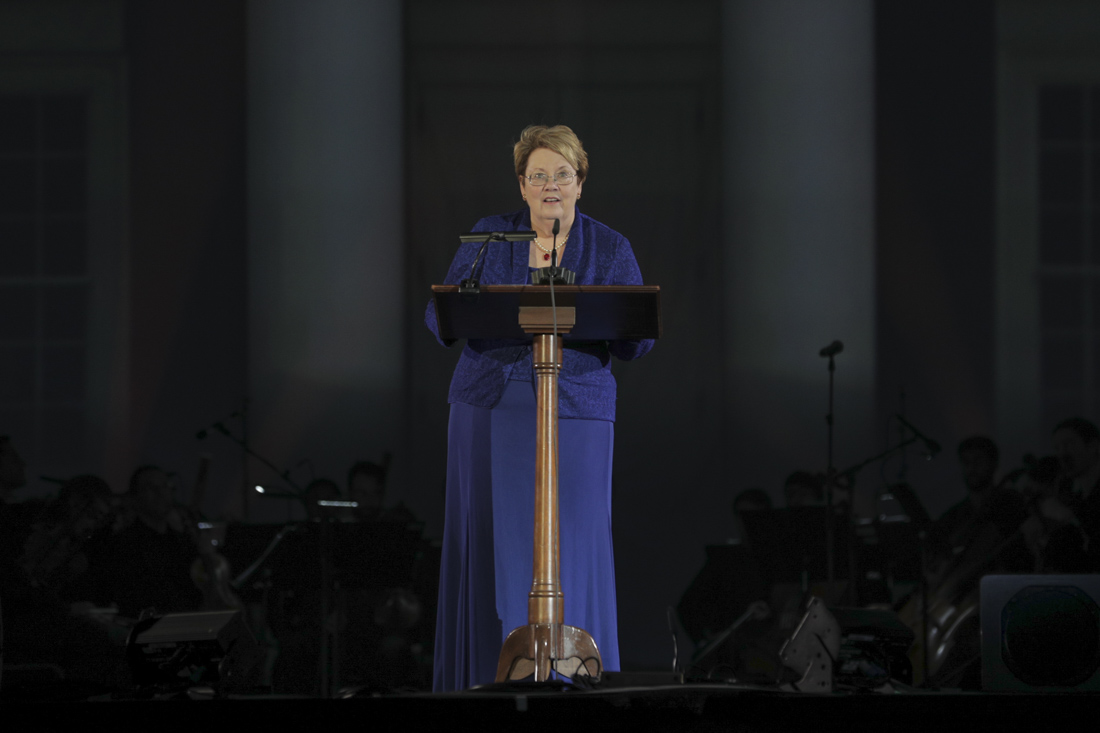 UVA President Teresa Sullivan stands on stage at a podium