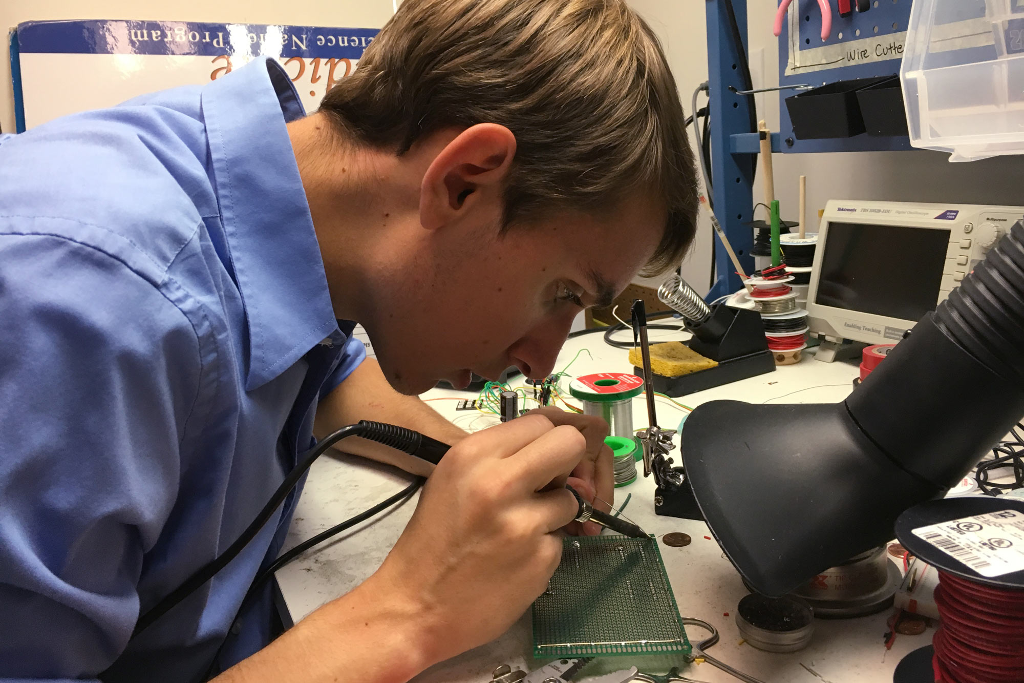 A student soldering electronics