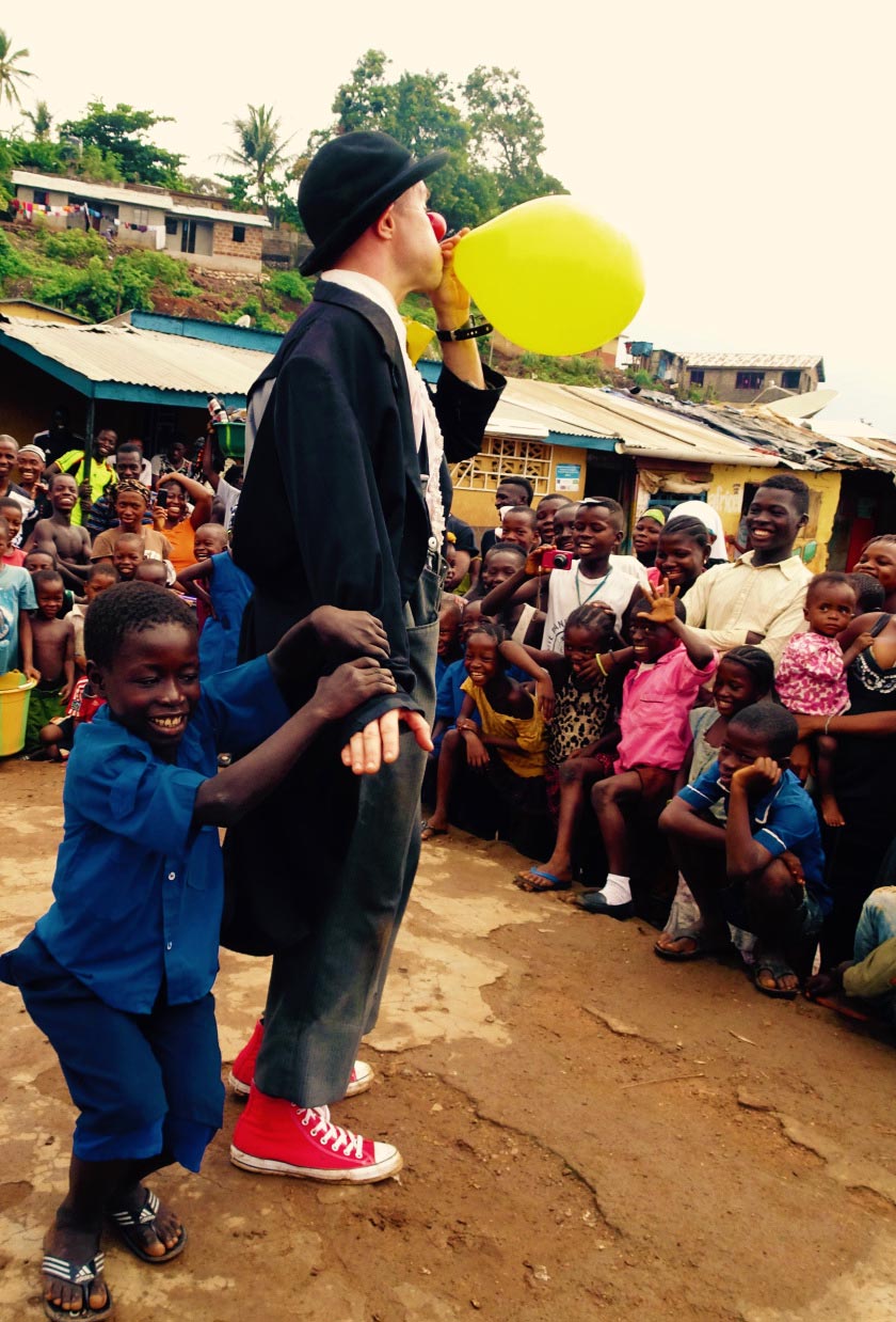 Tim Cunningham performing a balloon trick in an African village