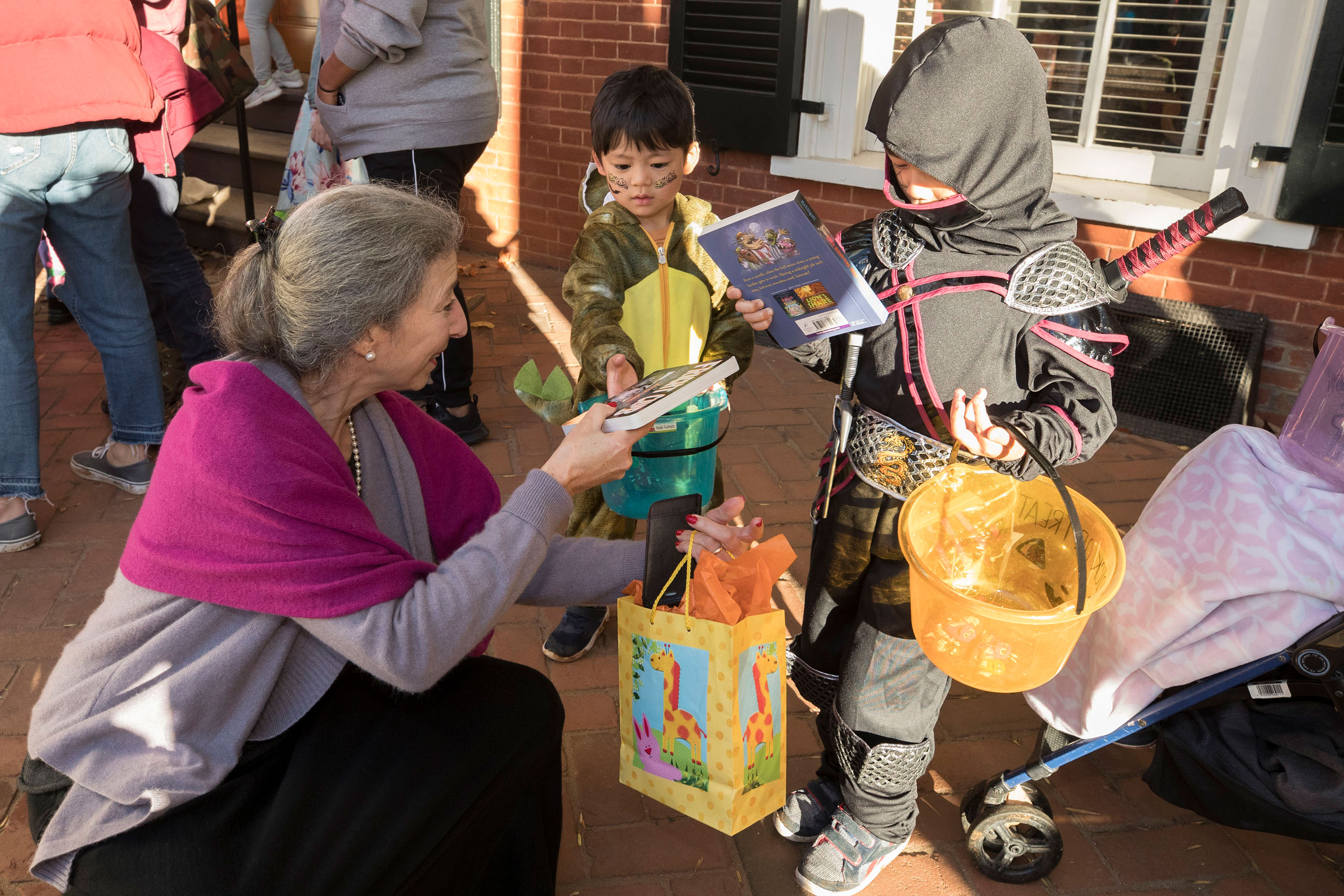 Jeanna Beker hands out free books to trick or treaters
