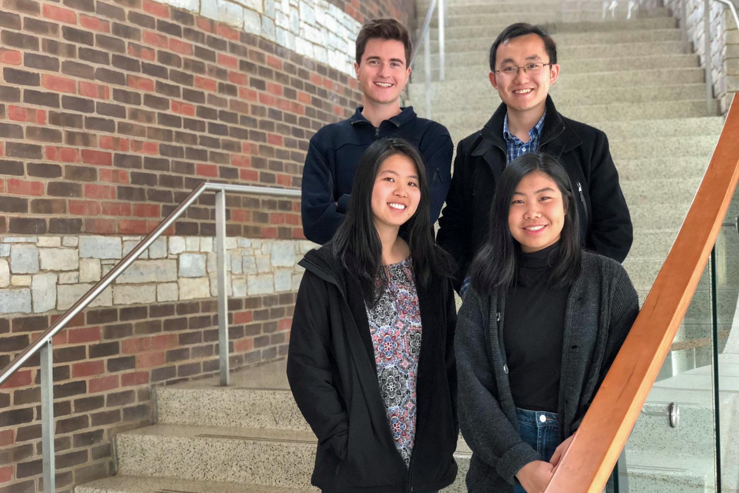  Clockwise from top left, students Jackson Samples, Eric Xu, Eileen Ying and Irena Huang stand on steps smiling for the camera