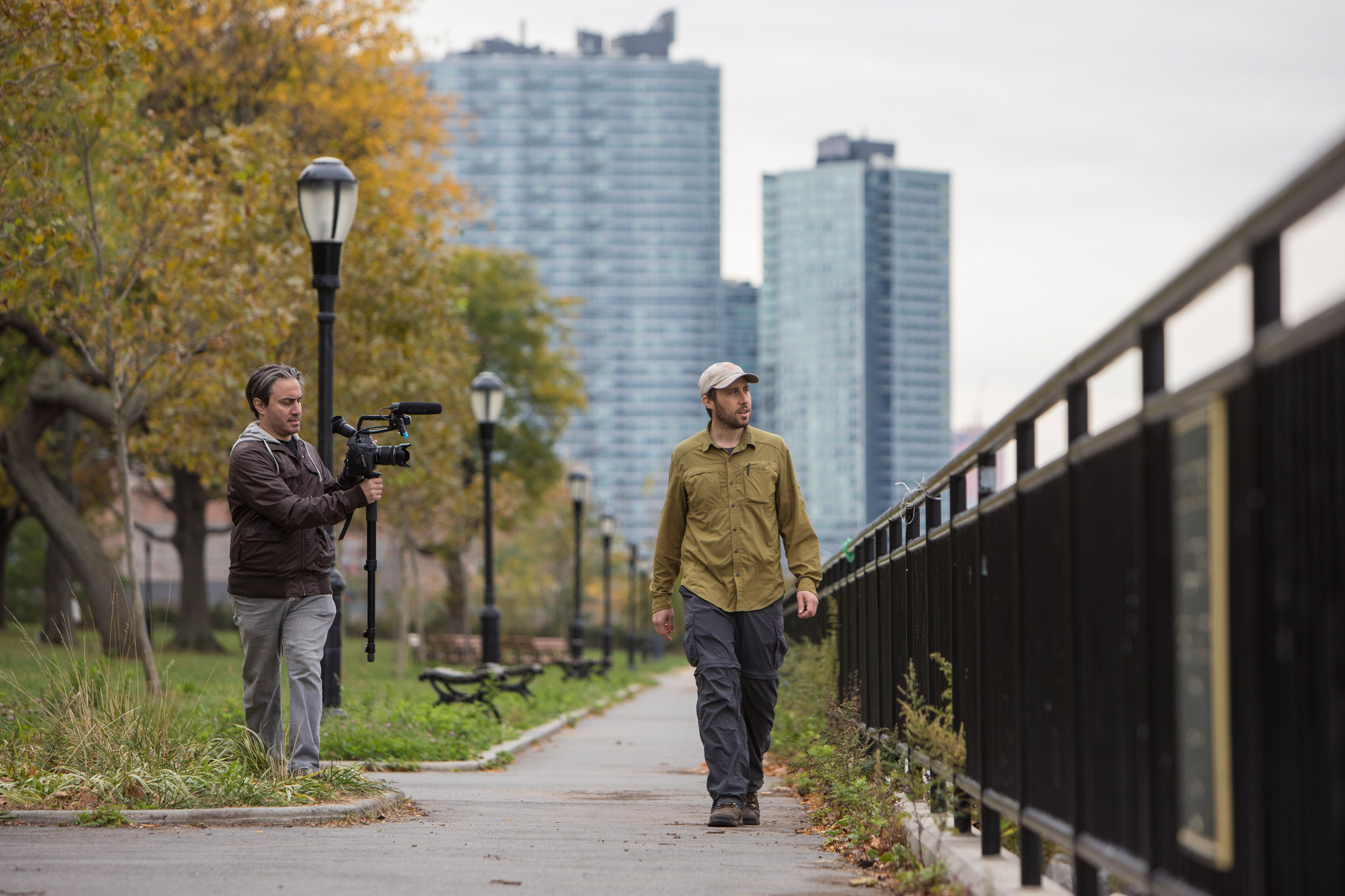 Matt Green walks in Long Island City, Queens with a camera man following him