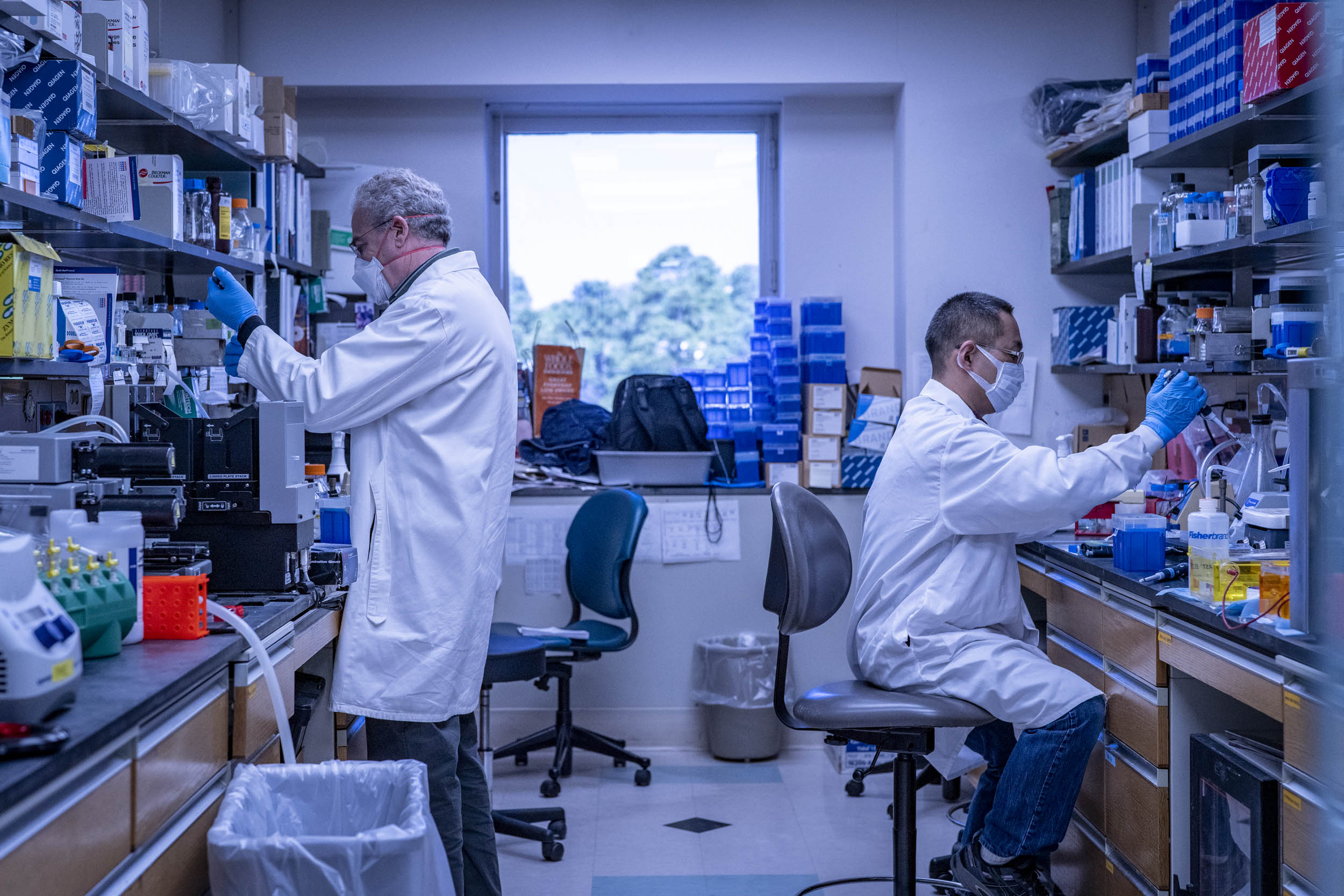 two people working in a lab  with their backs facing each other