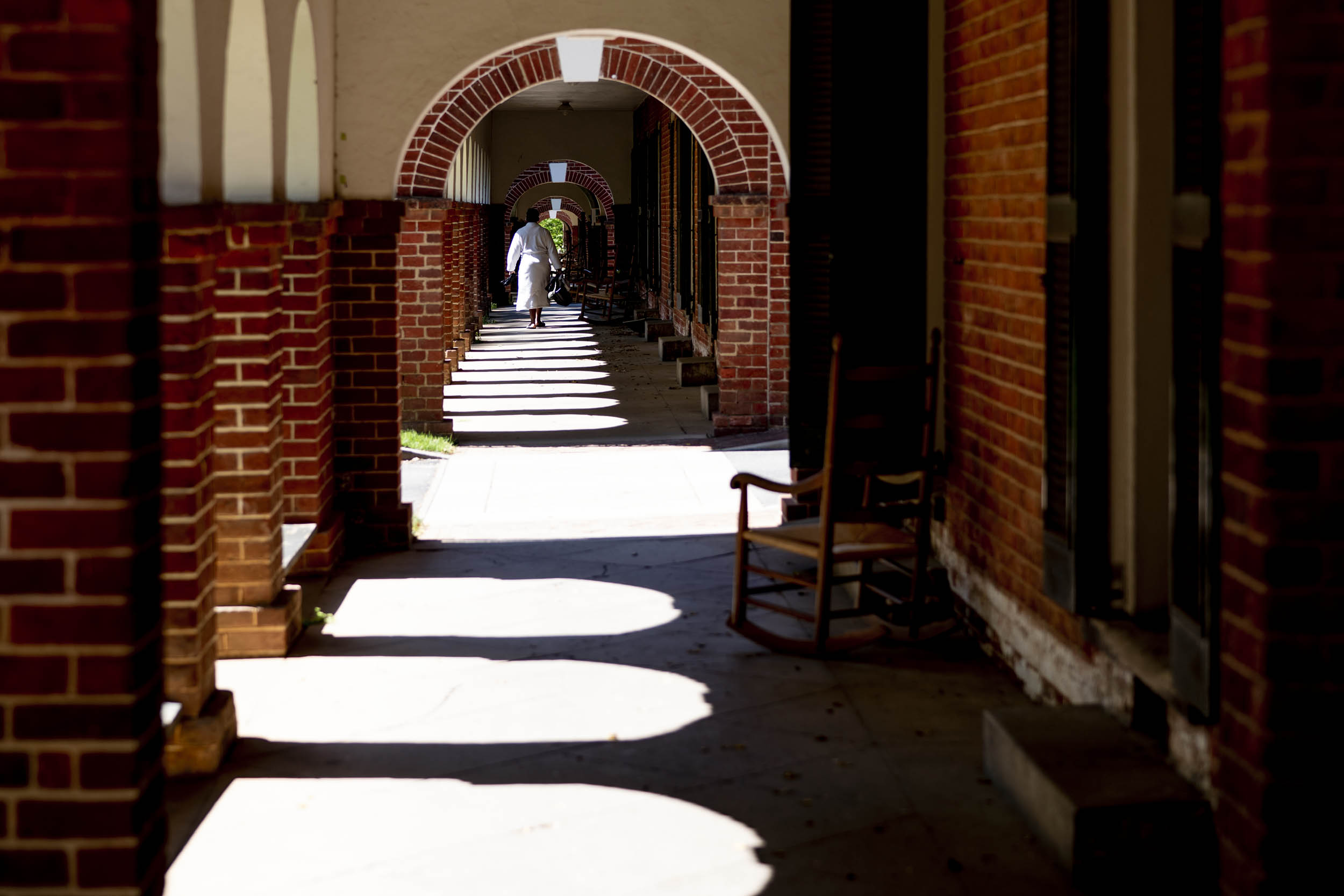 The Lawns walkway with the arches casting shadows onto the walkway