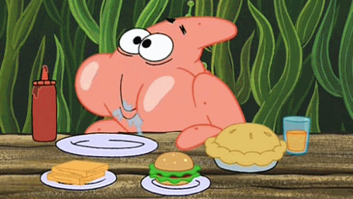 Patrick from Spongebob with a mouth full of food at a picnic table.