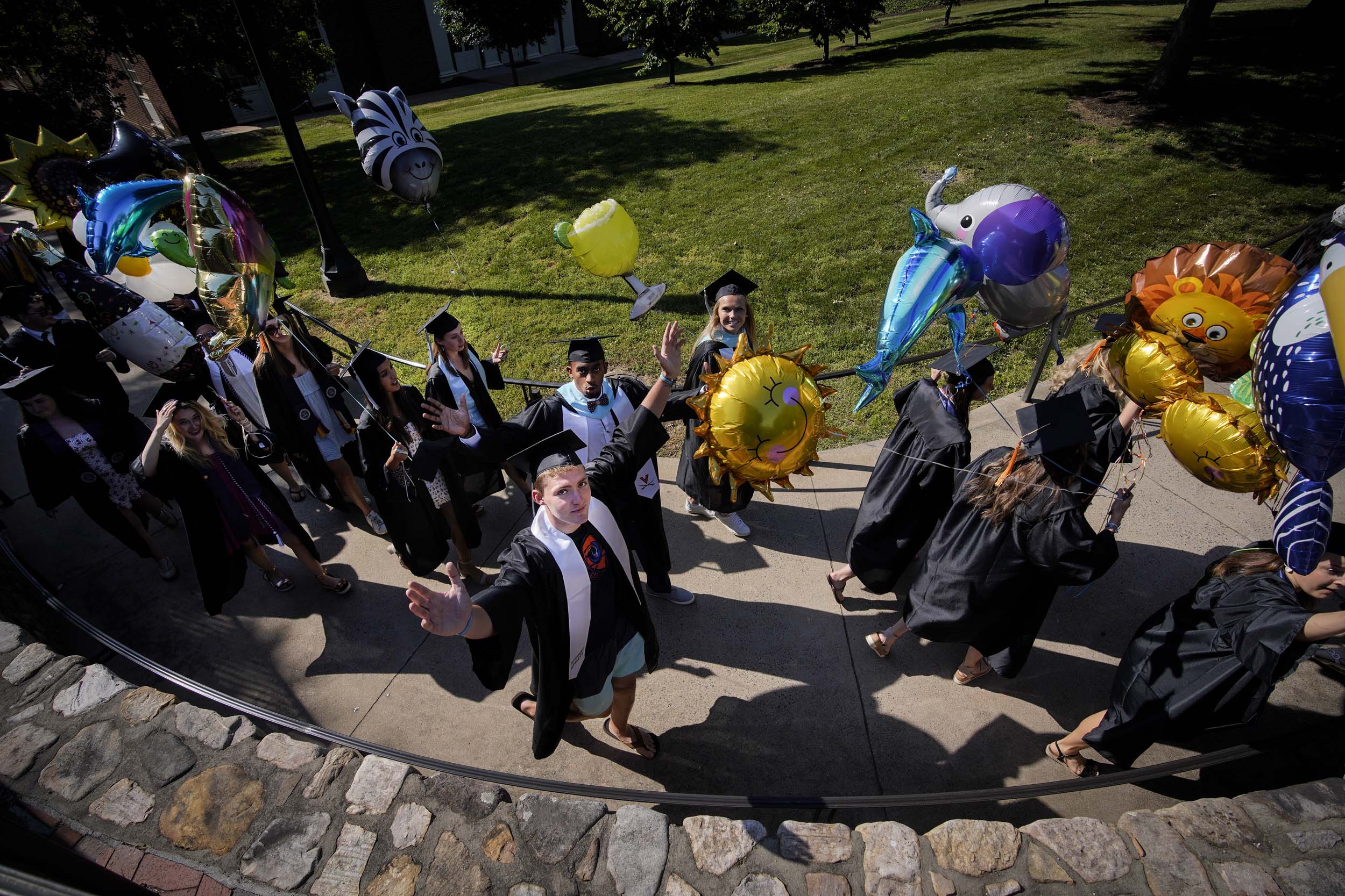 Graduates walking on a sidewalk to Final Exercises