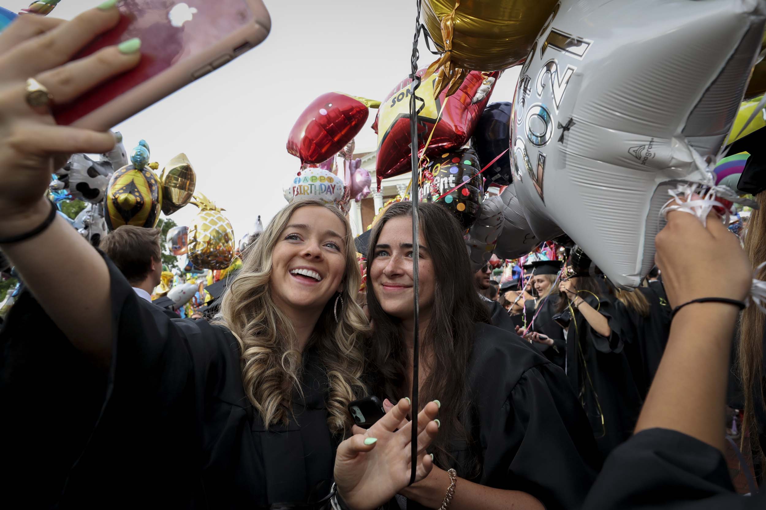 Graduates pose together for a selfie