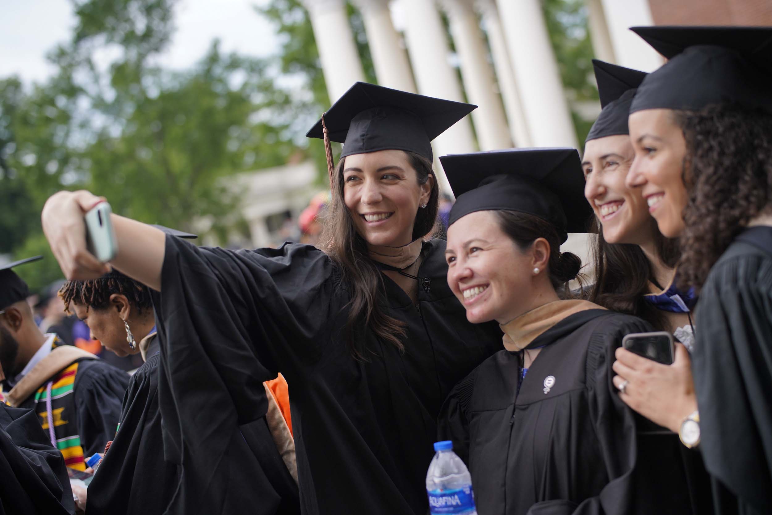 Graduates pose together for a group selfie