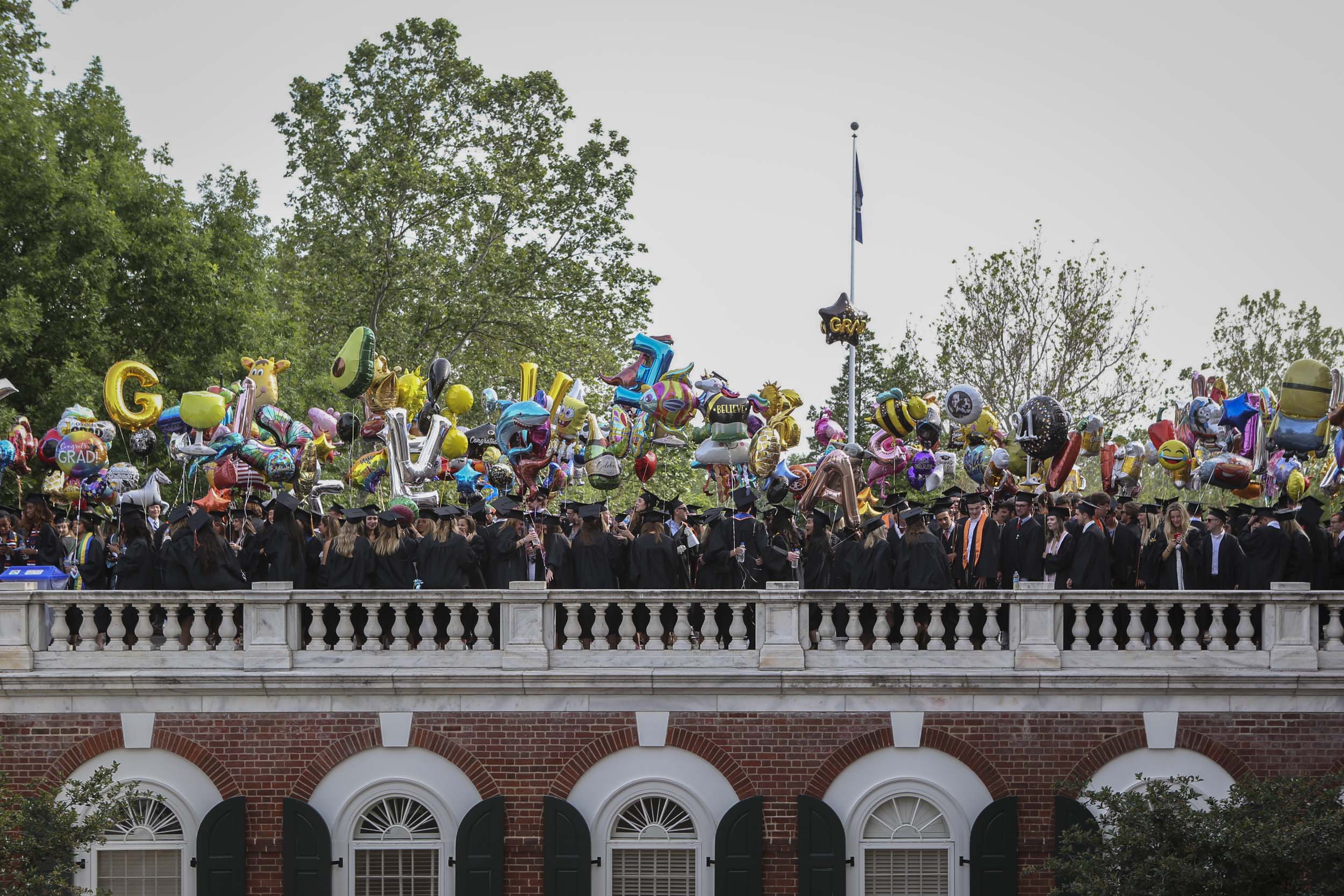 Graduates standing on the Rotunda with balloons