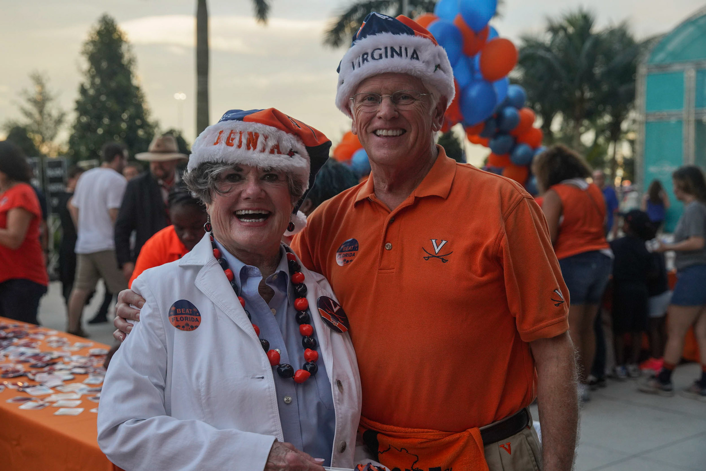 Les Wagner, right, and Elizabeth Brey, left stand together for a photo decked out in Blue and orange