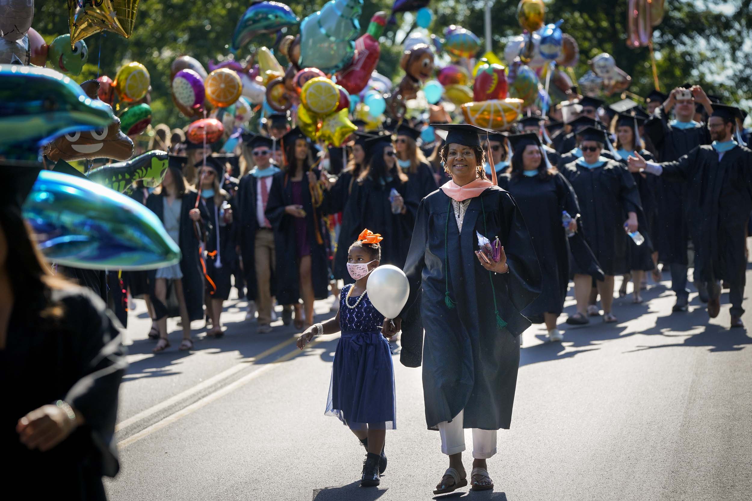 Graduate walk to Final exercises with her daughter