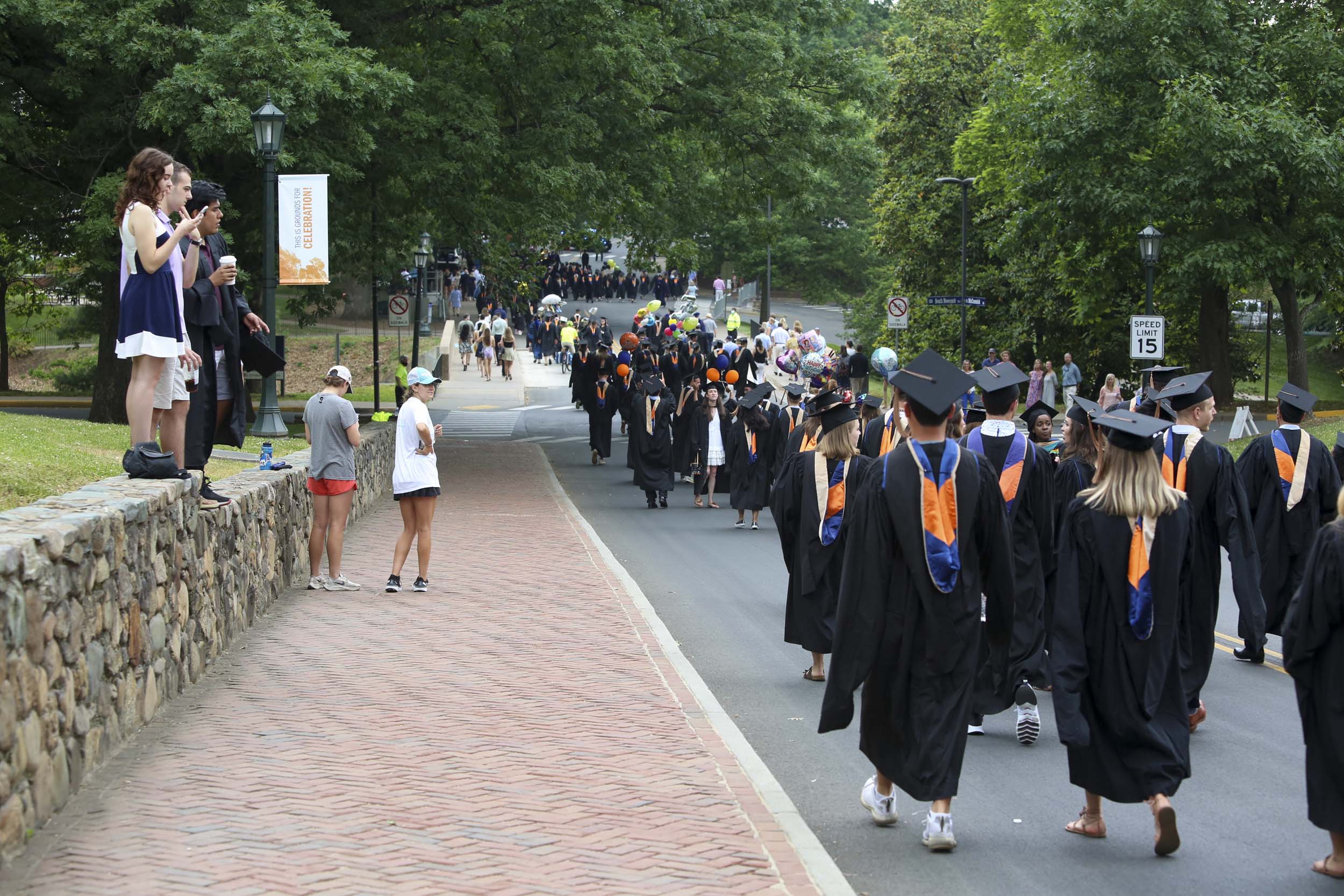 Graduates walking down the road to Final Exercises