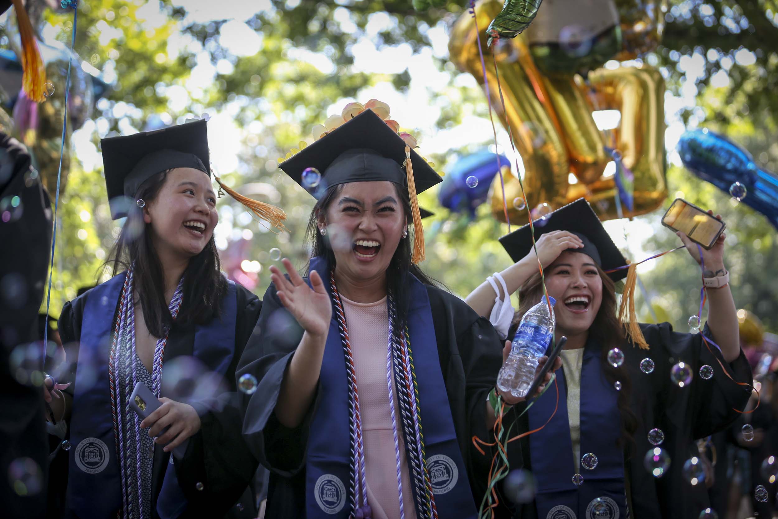 Graduates walking through bubbles