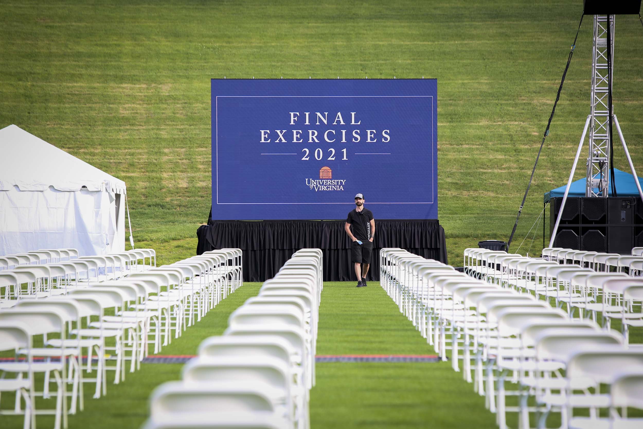 Chairs lined up in columns in front of a sign that says Final Exercises 2021 with the UVA stacked logo