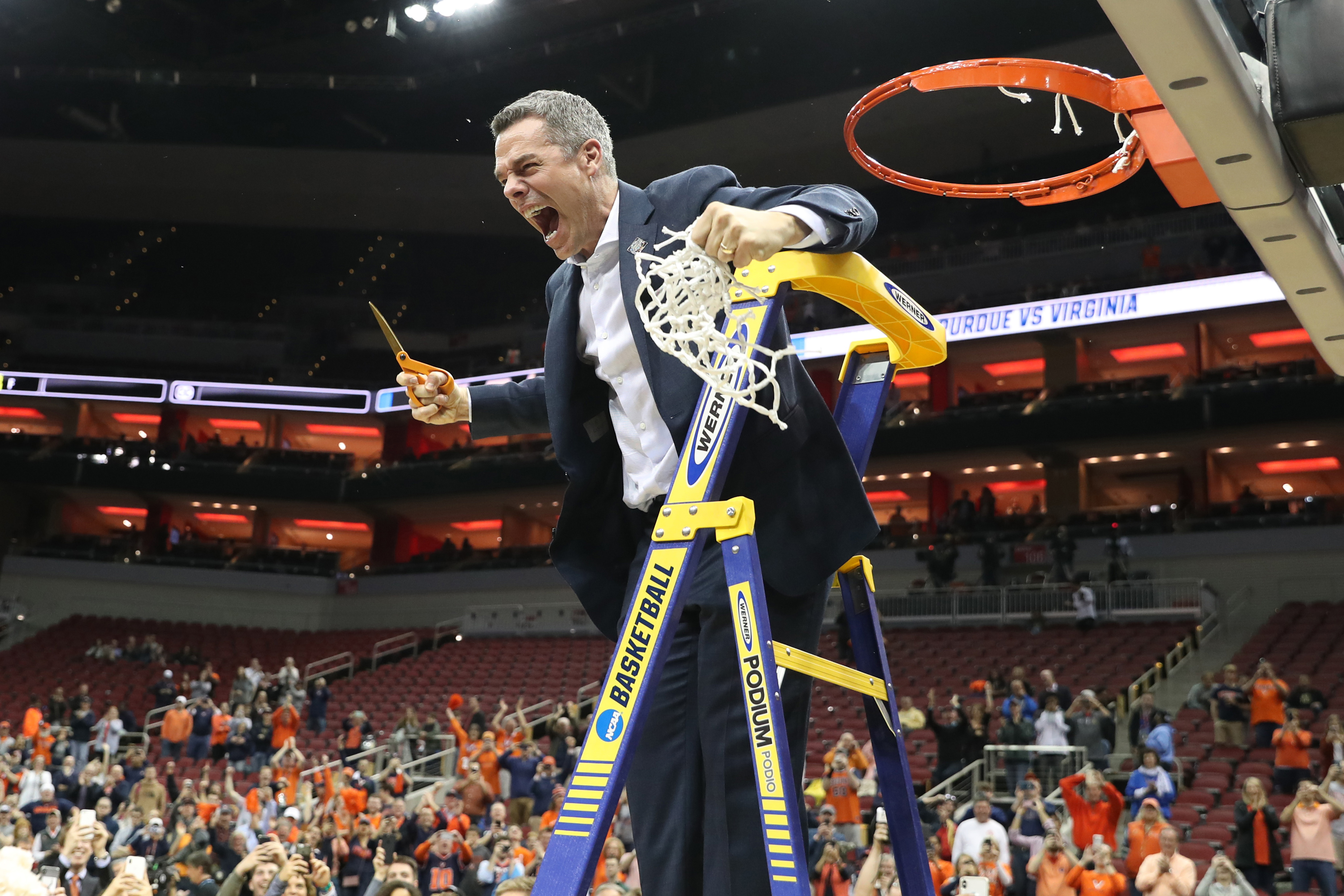 Tony Bennett yells in triumph after cutting the net