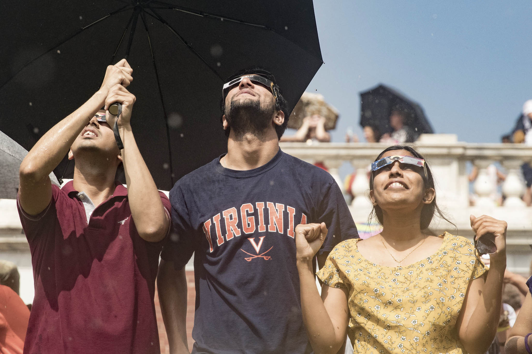 Students wearing eclipse glasses looking at the eclipse