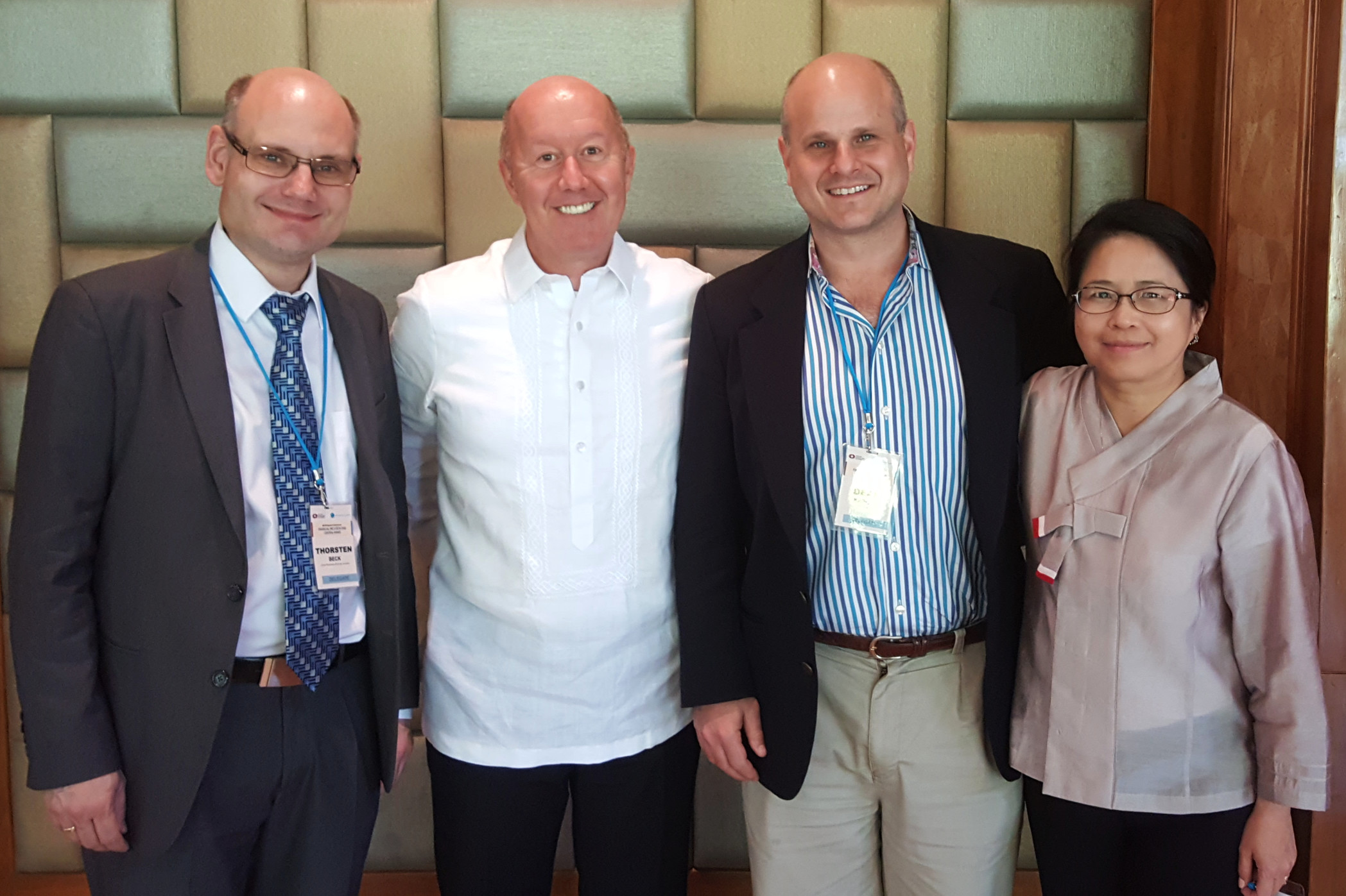 Thorsten Beck, Francis Warnock, Dean Karlan and Veronica Warnock were each selected to share their research on financial inclusion with executives from Asia’s central banks. All four are either faculty members or graduates of UVA. (Contributed photo)