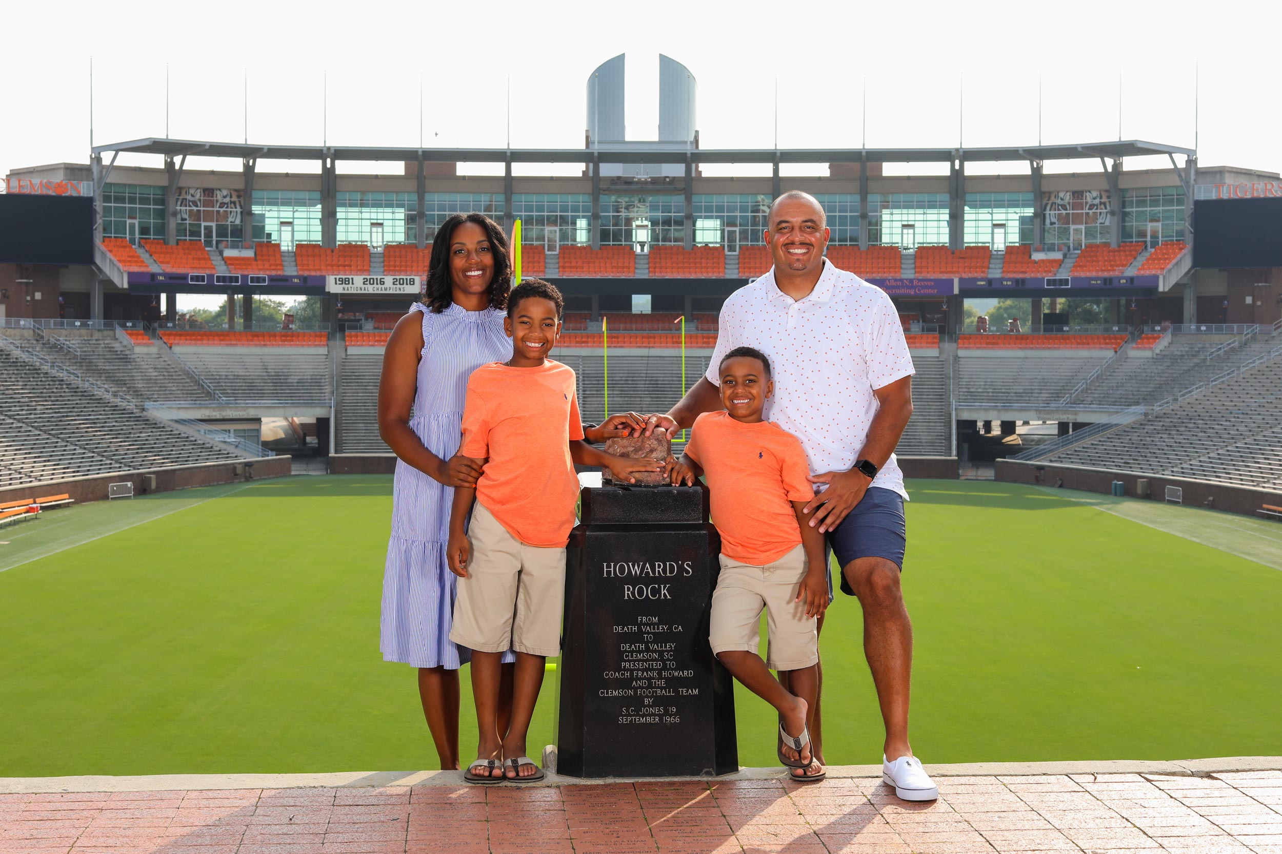 Coach Elliot and His family standing at Howards Rock at Scott Stadium