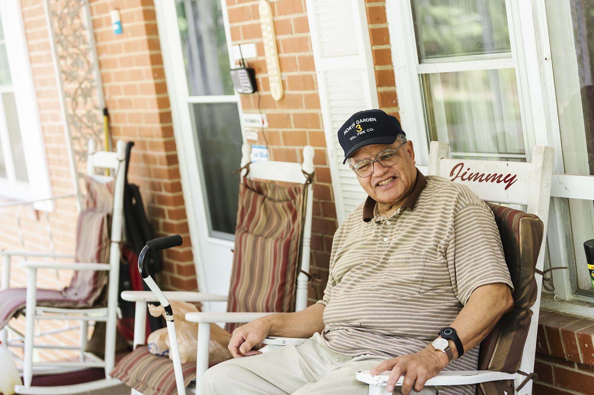 Man sitting in a rocking chair on a porch