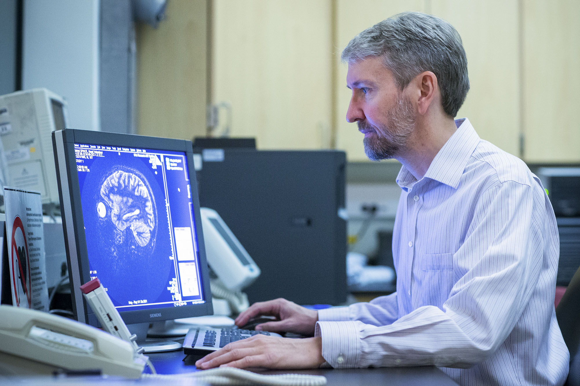 Craig Meyer looking at an MRI scan