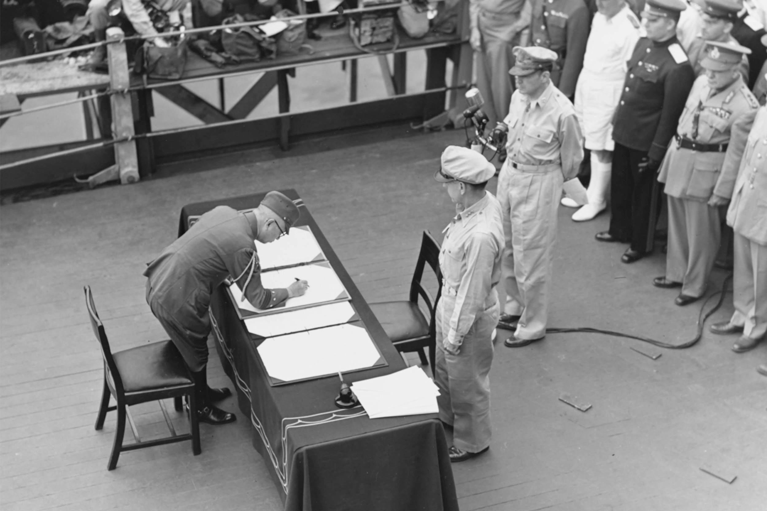 Gen. Yoshijiro Umezu signs the Instrument of Surrender on the USS Missouri with UN commanders