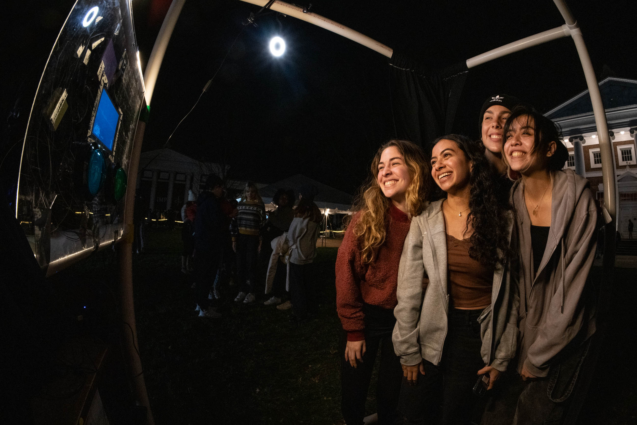 UVA Students taking a photo together from a photo booth
