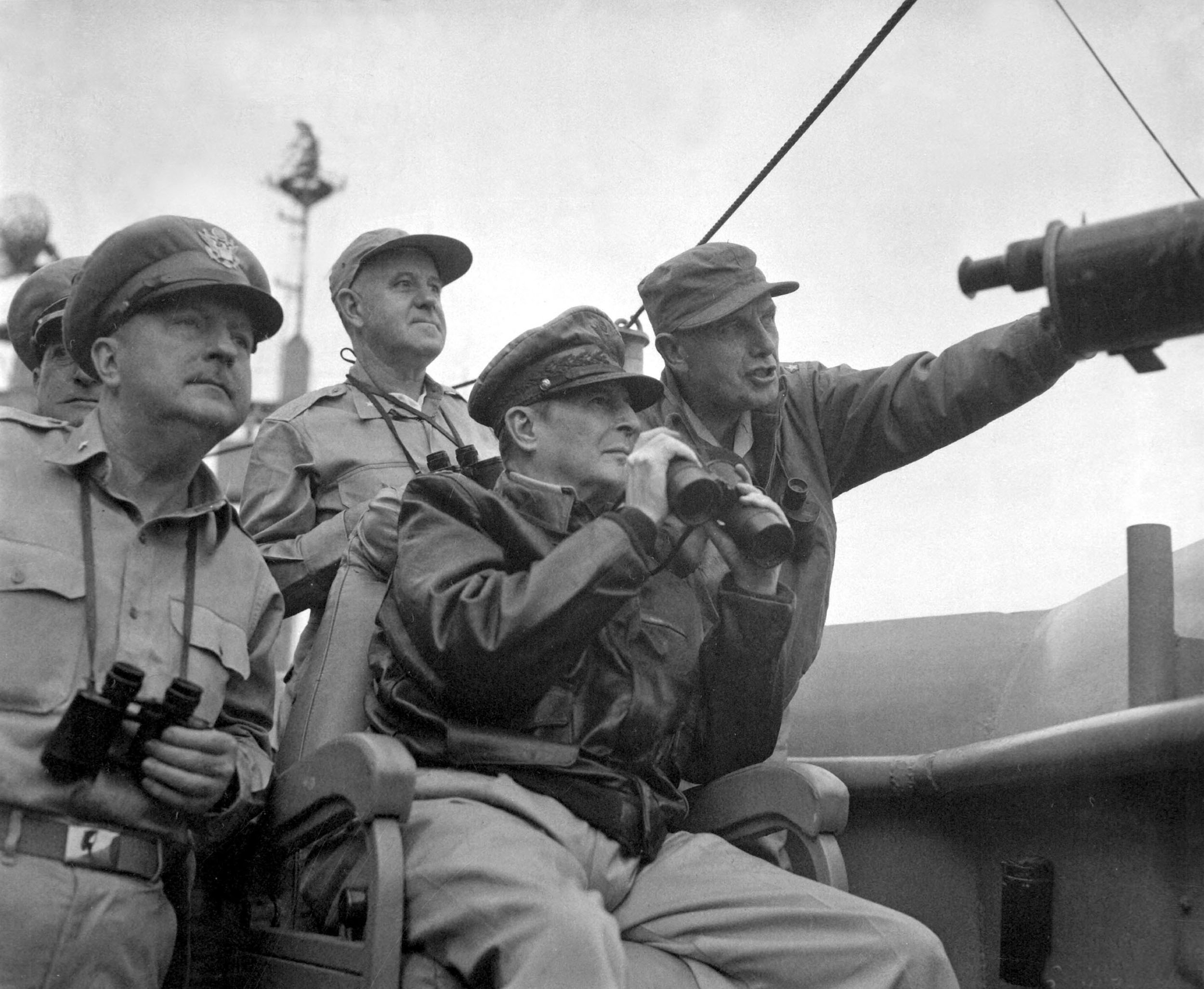 Army Gen. Douglas MacArthur looking at the bombing of Incheon, south Korea from his warship